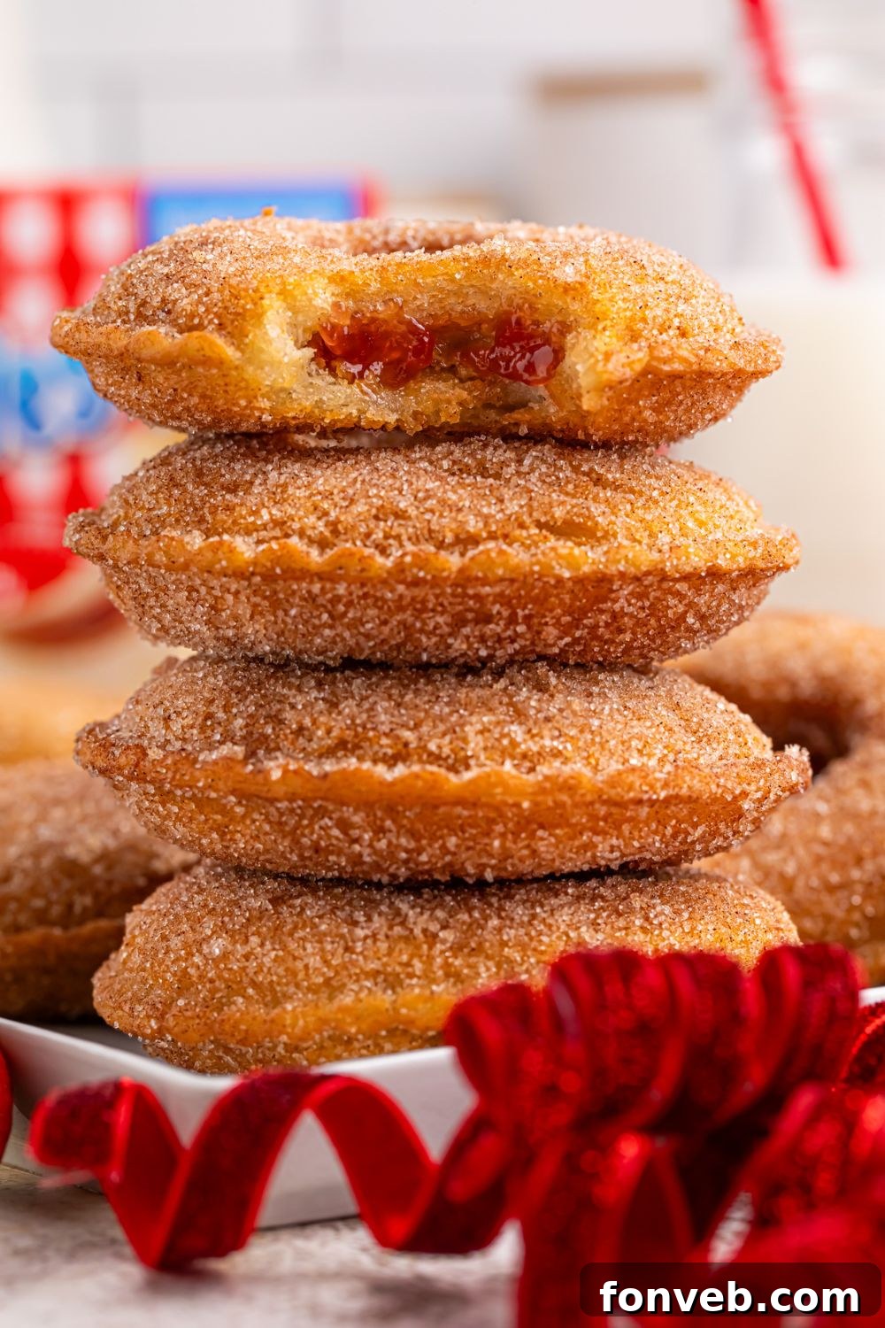 Fried Uncrustables stacked on a plate with top one that has a bite taken out of it 