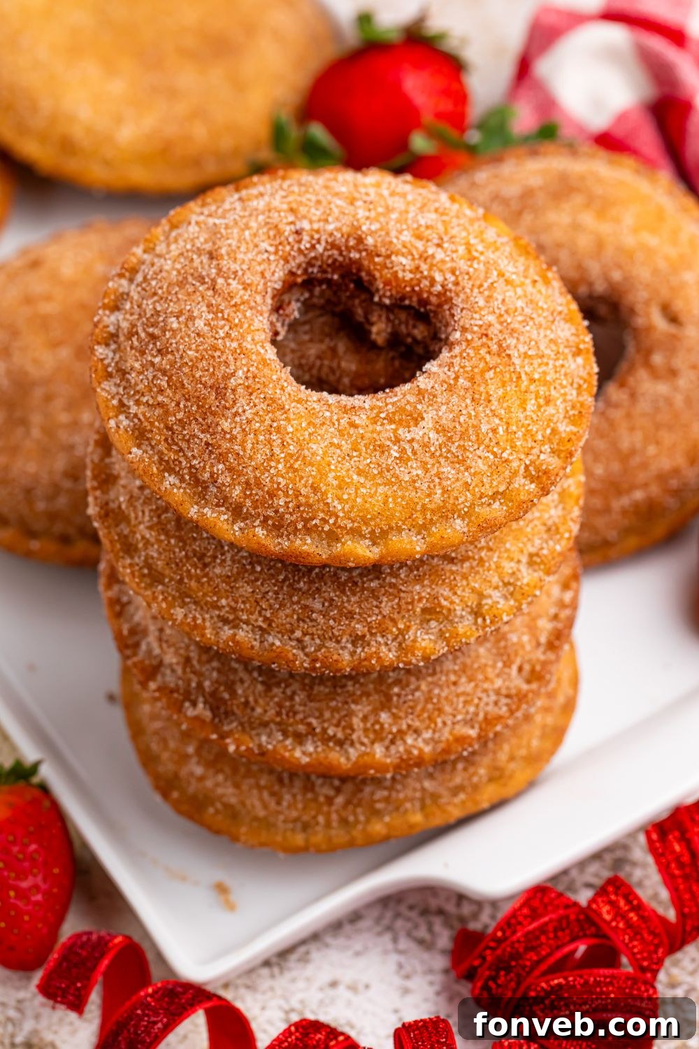 Fried Strawberry Uncrustables stacked on plate in a tower 