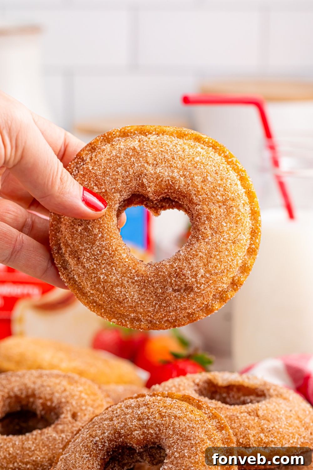 hand holding a Fried Strawberry Uncrustable with heart cut out in center 