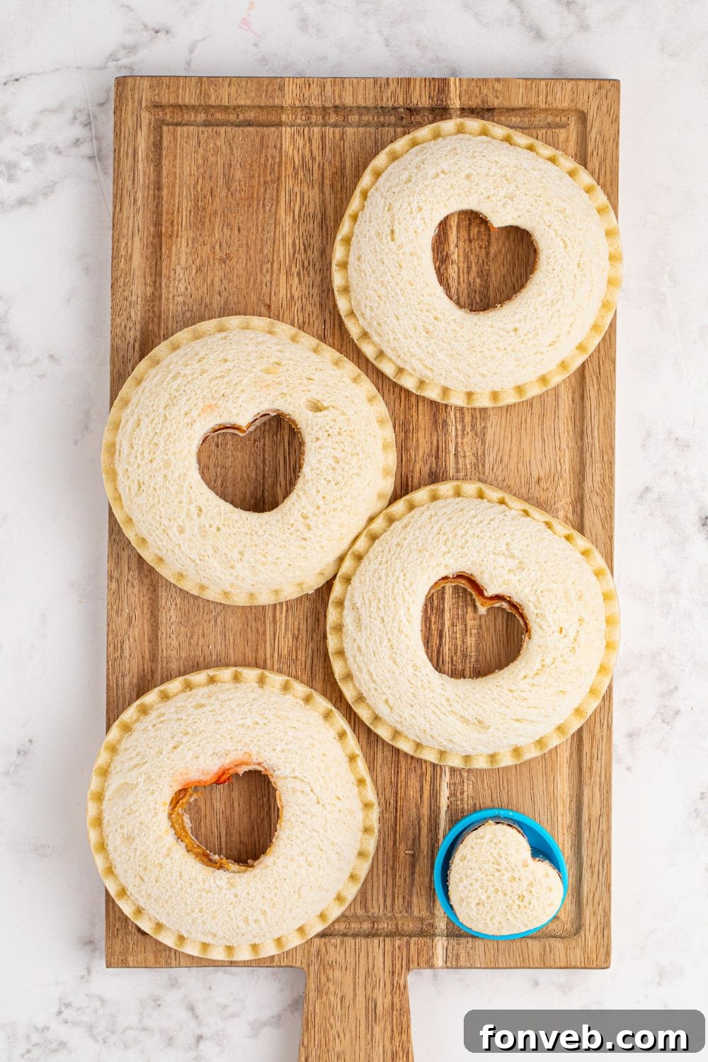 Homemade Strawberry Uncrustables with hearts cut out in center of each one with a cookie cutter 