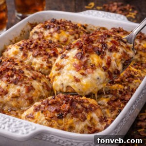 Four Cheese Bacon Stuffed Smothered Chicken Casserole in a white pretty baking dish