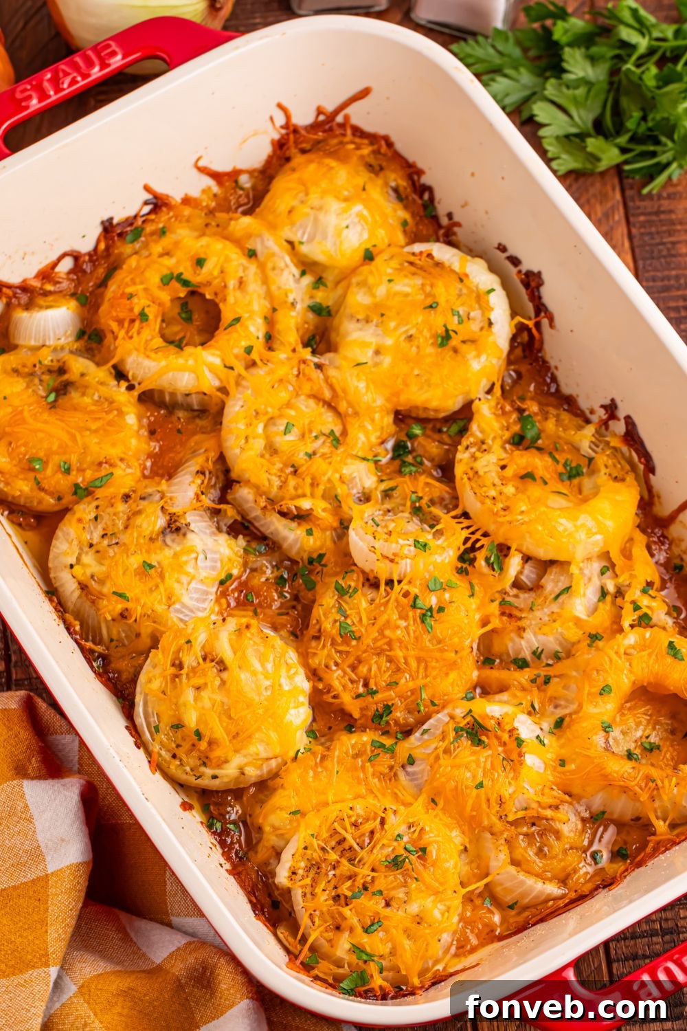 Cheesy Tennessee Onions in a casserole dish sprinkled with parsley on top 