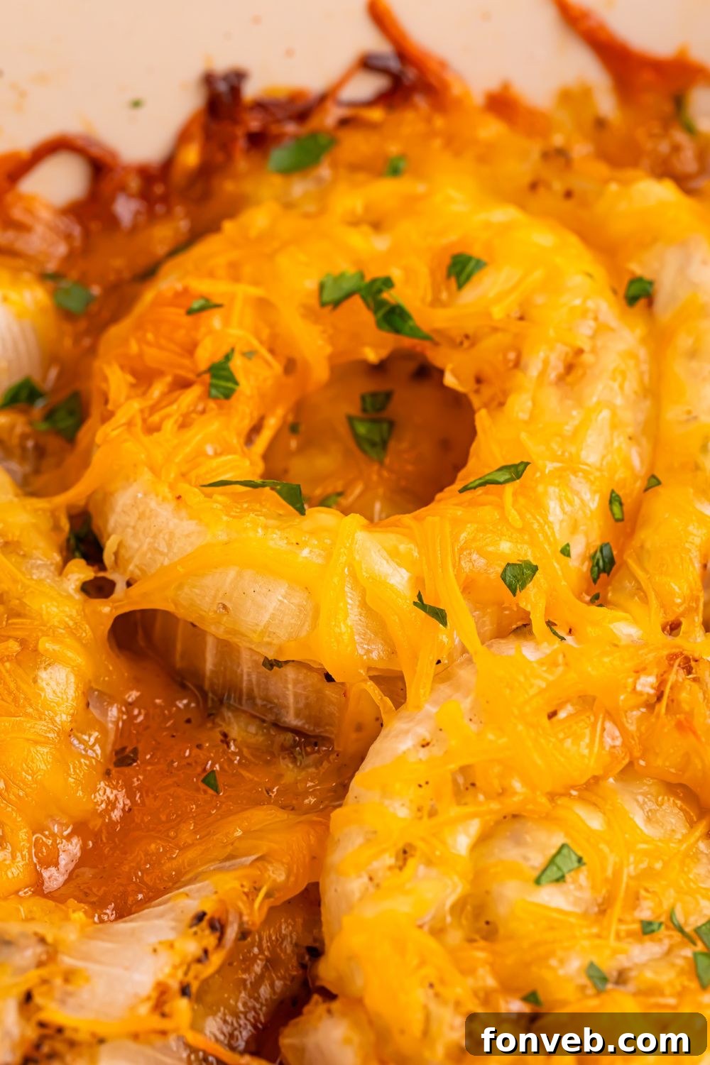 close up of Cheesy Tennessee Onions in a pan all baked up golden brown