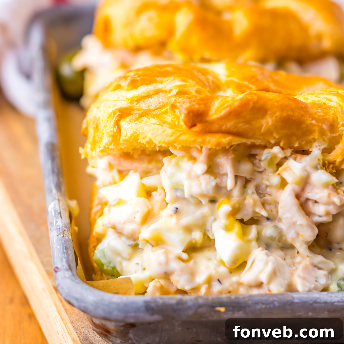 Close up view of a chicken salad stuffed croissant. 