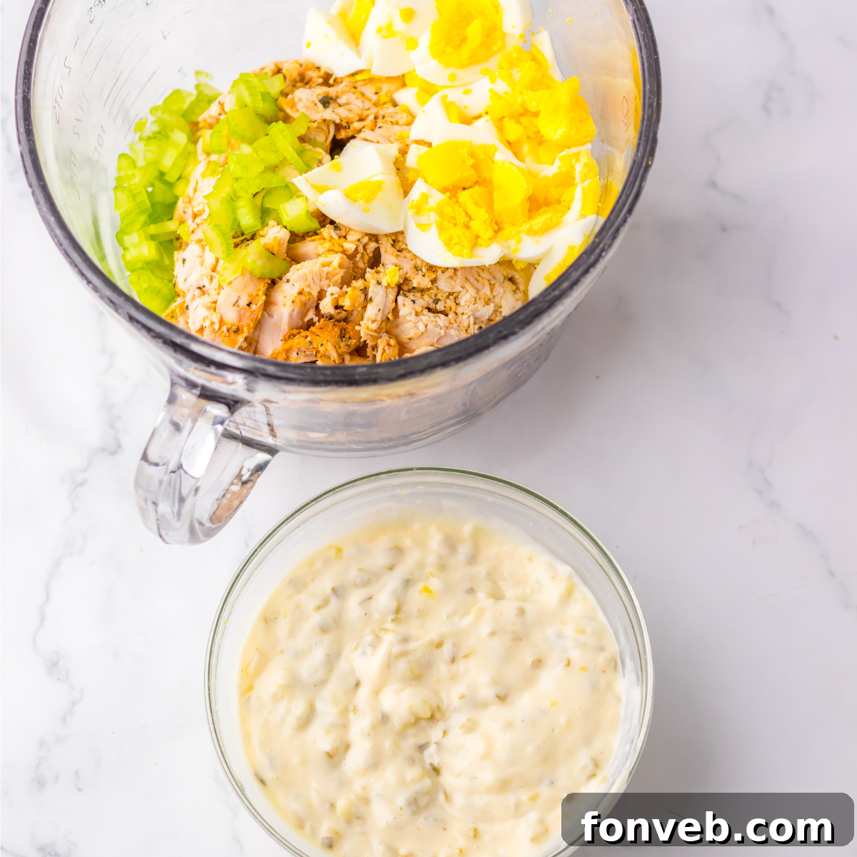 In process shot of combining ingredients for this chicken salad recipe. 