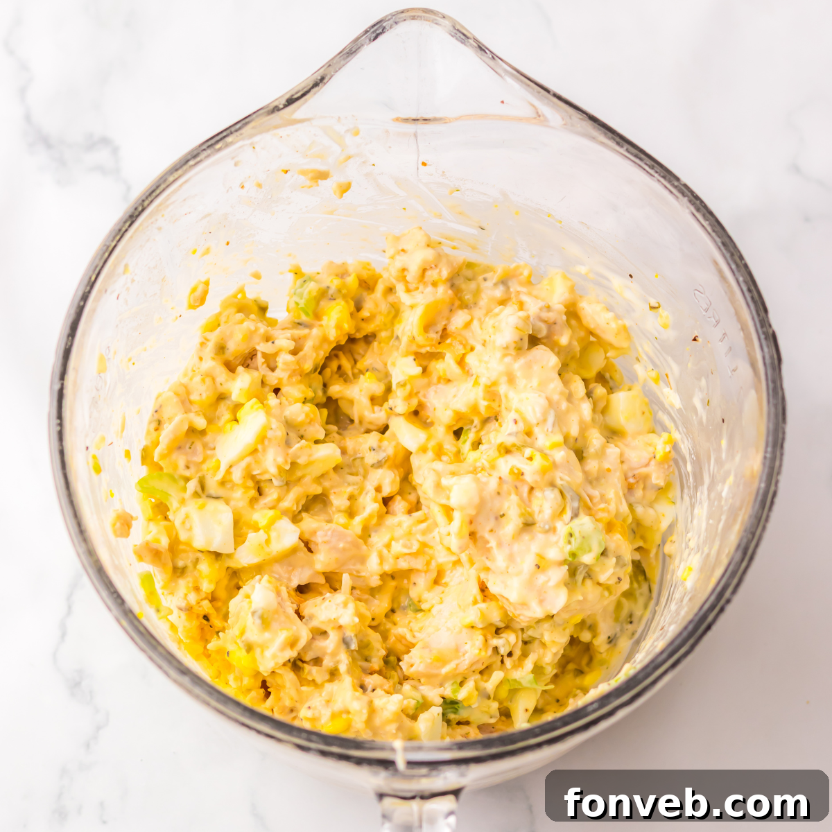 All of the ingredients mixed together in a large glass bowl. 