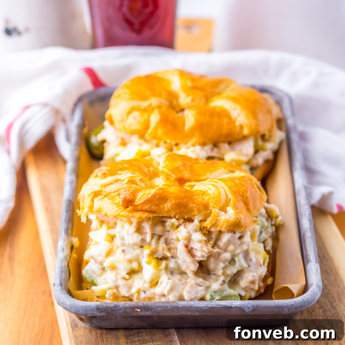 Side view of two chicken salad sandwiches on a tin tray.  