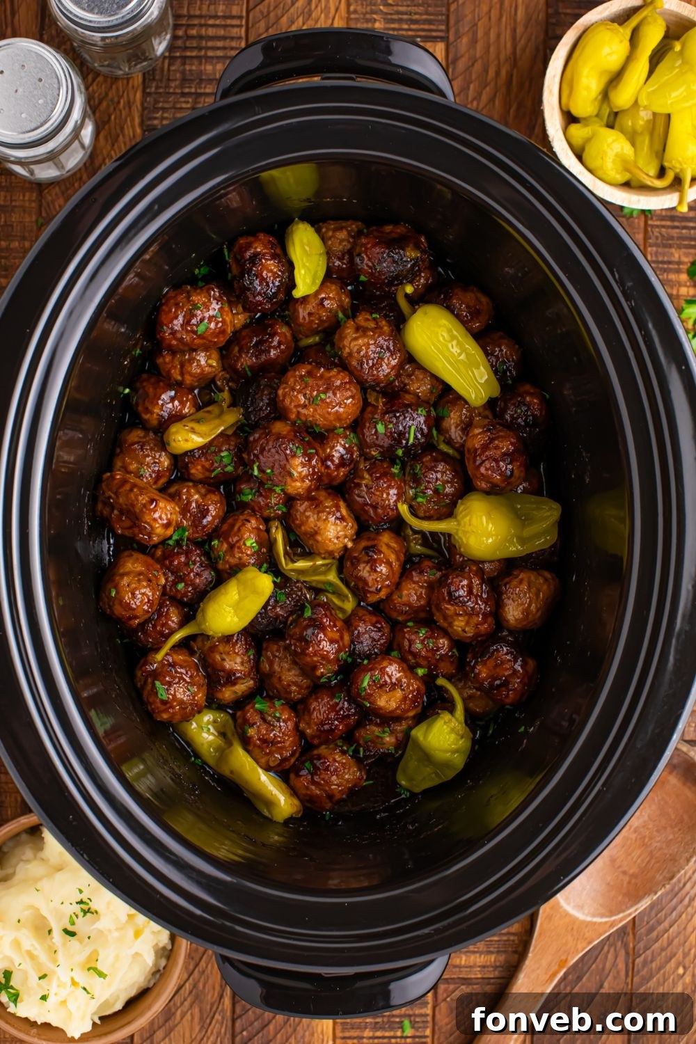 overhead look of Crockpot Mississippi Meatballs with peppers on top of the meatballs 