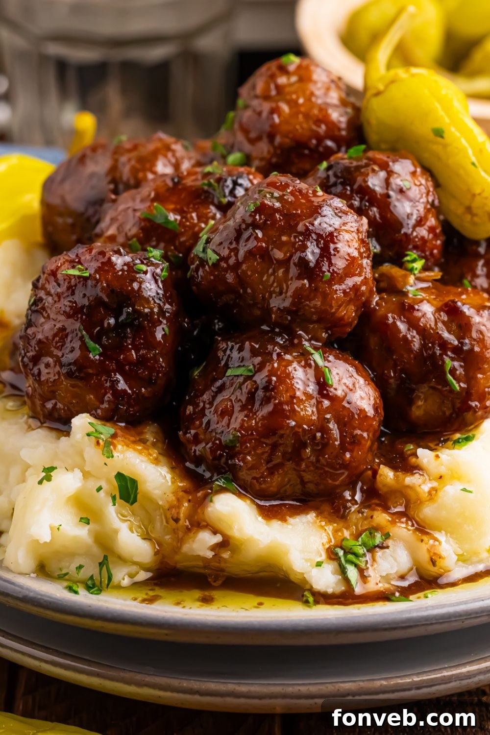Crockpot Mississippi Meatballs piled on a plate with mashed potatoes