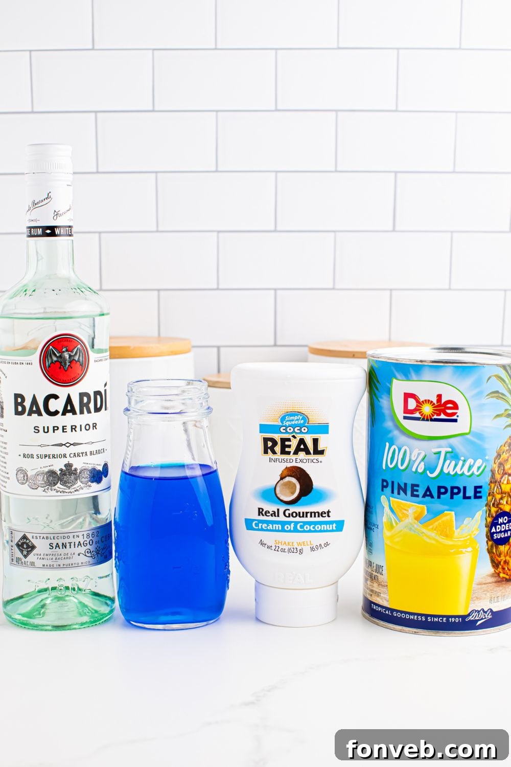 ingredients for Frozen Blue Hawaiian Cocktail on table
