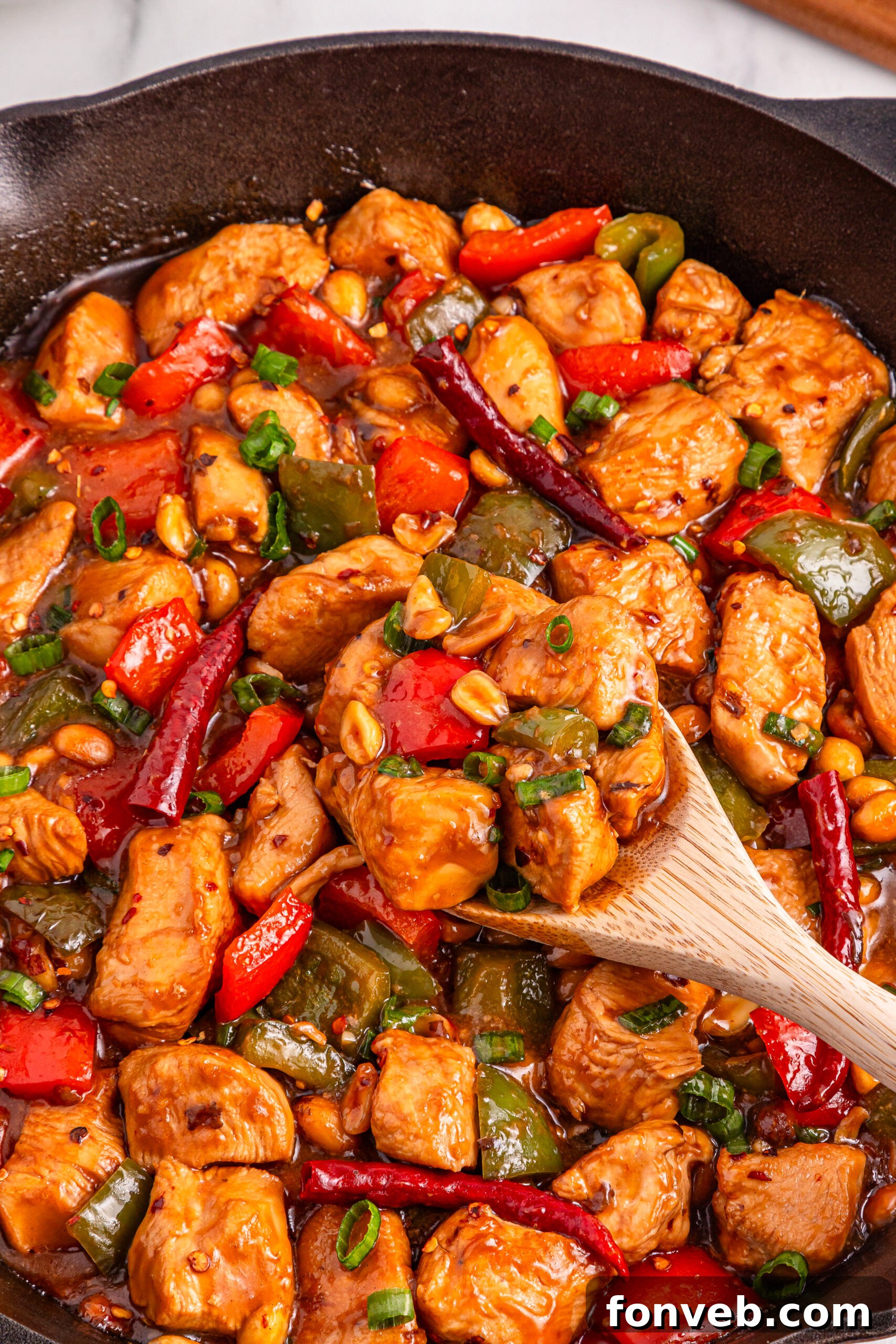 A vibrant, delicious Better Than Takeout Kung Pao Chicken stir-fry presented in a classic cast iron skillet, ready to serve.