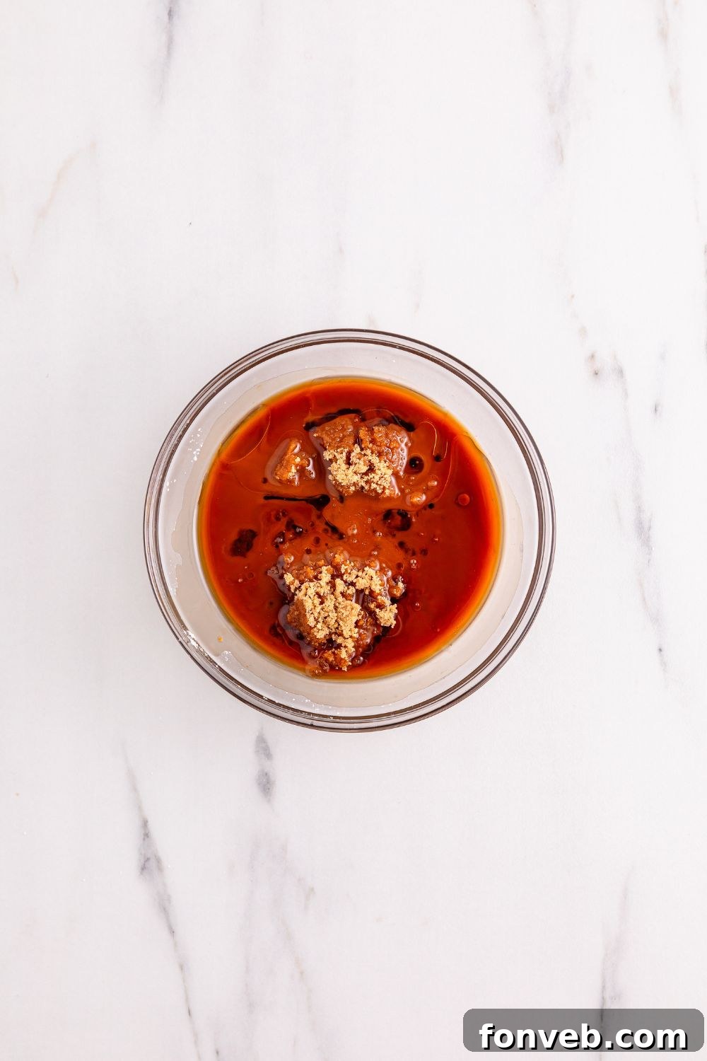 A small glass bowl holds a rich, glossy sauce, prepped for use in the Better Than Takeout Kung Pao Chicken.