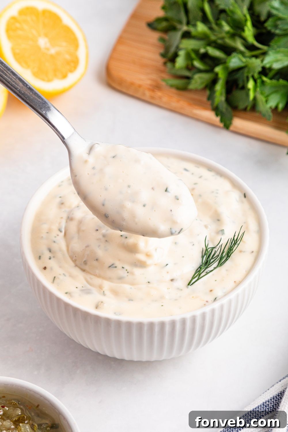 Effortless Homemade Tartar Sauce Beats Store Bought 13 Easy Homemade Tartar Sauce freshly mixed in a bowl, with a garnish of dill sprigs beside it, ready to serve.