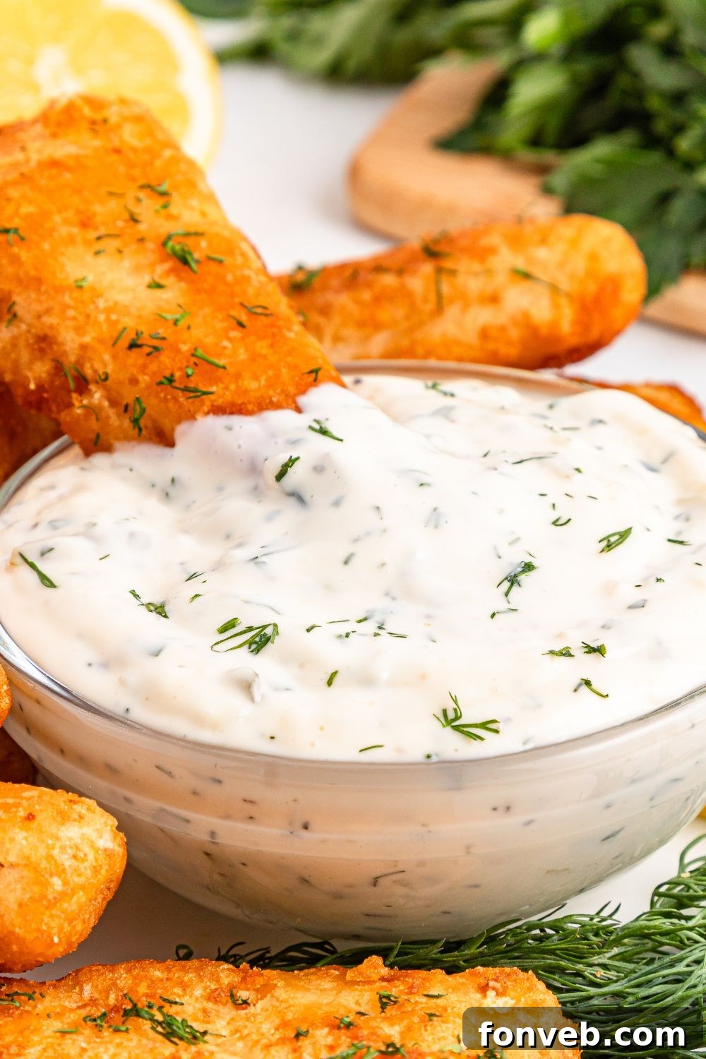 Effortless Homemade Tartar Sauce Beats Store Bought 23 Easy Homemade Tartar Sauce in a bowl with a fried fish fillet dipped into it, highlighting the perfect pairing.