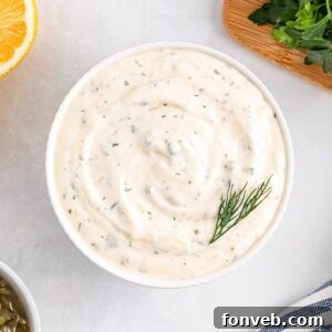 Easy Homemade Tartar Sauce in a white bowl on table with some dill garnish