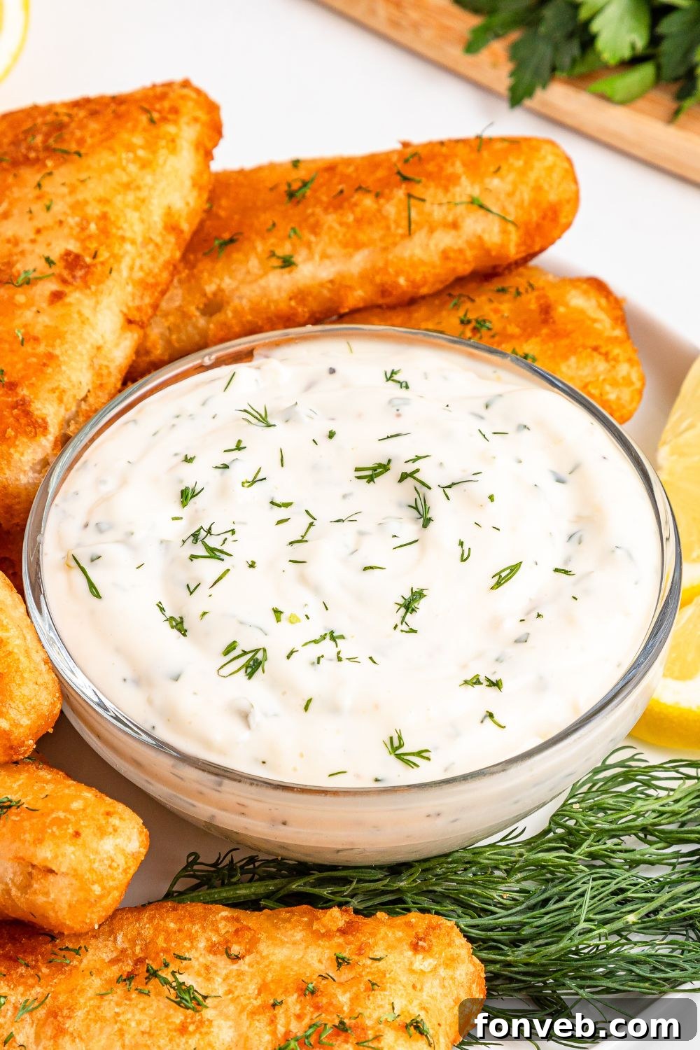 Effortless Homemade Tartar Sauce Beats Store Bought 9 Easy Homemade Tartar Sauce served in a bowl, with a side of perfectly cooked fish, suggesting a delicious pairing.