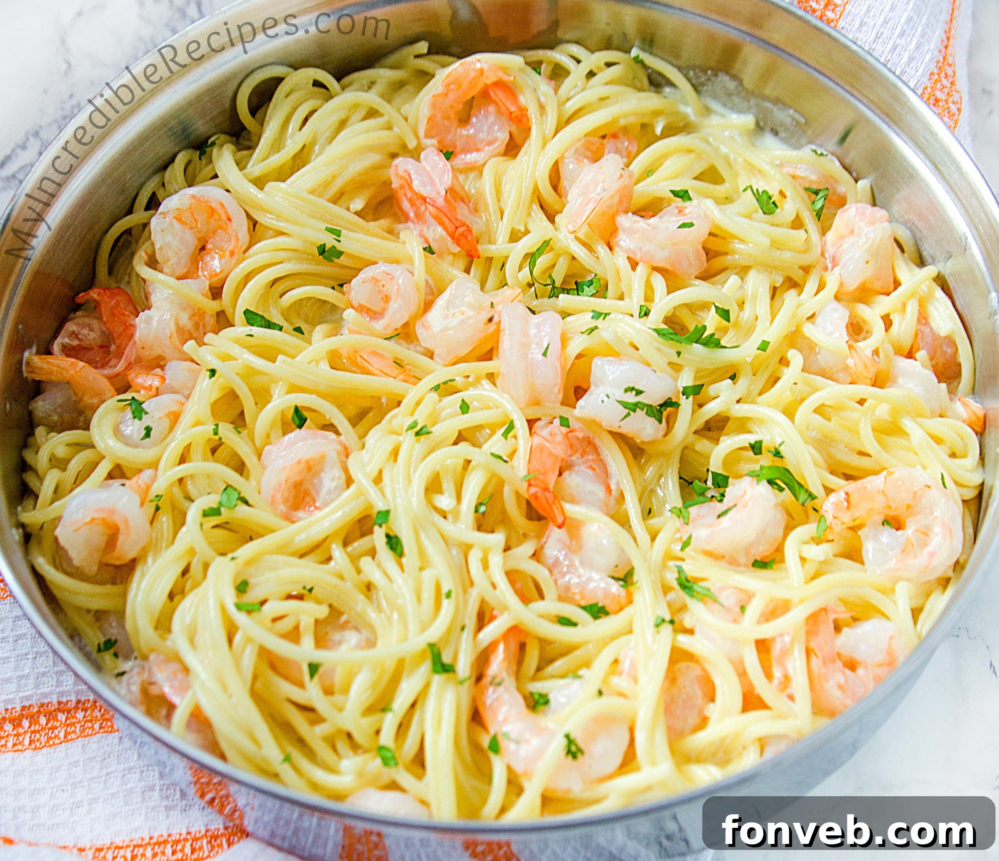 Close-up of Four Cheese Garlic Shrimp Pasta in a skillet, showcasing the creamy sauce and visible shrimp.