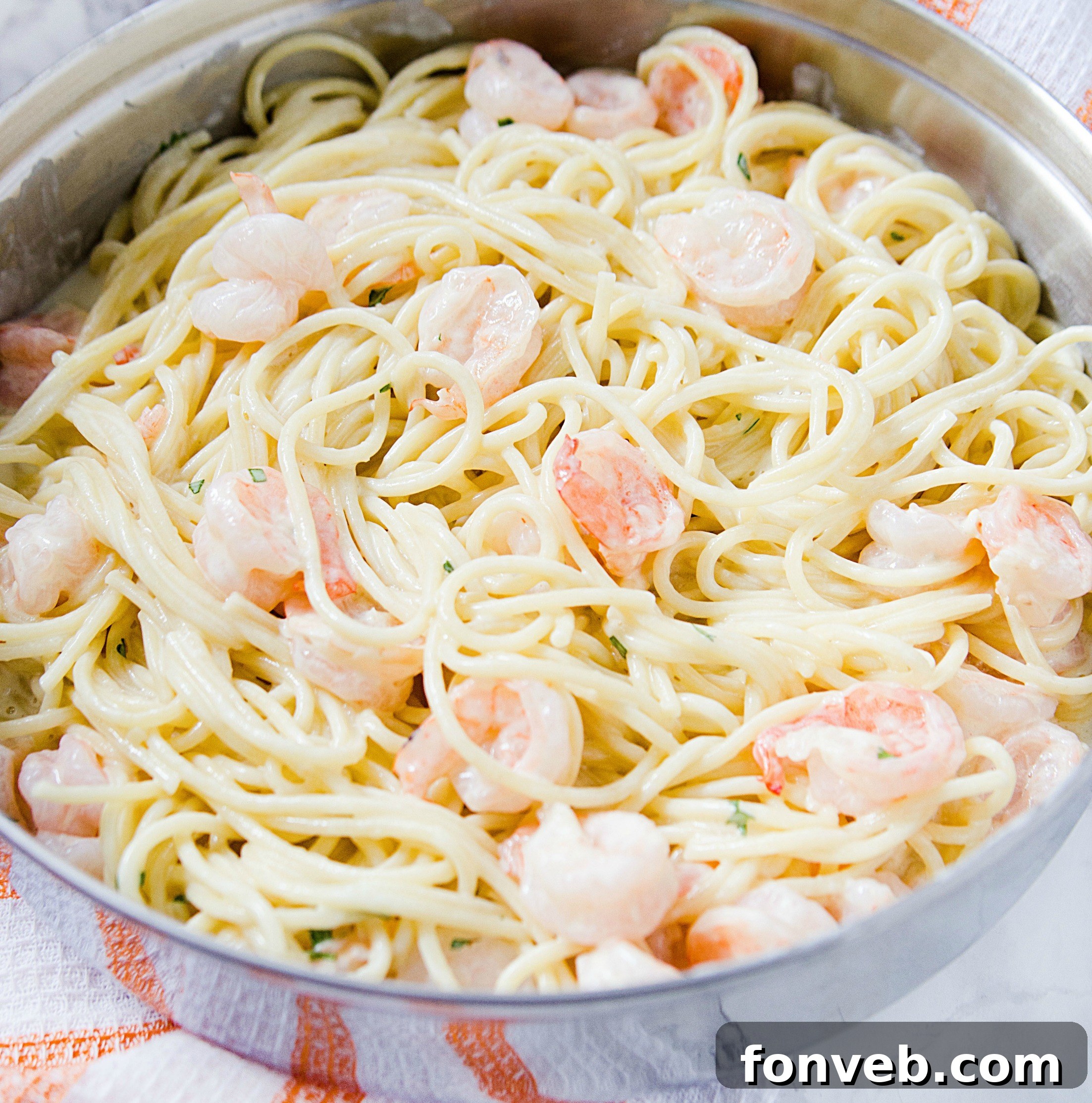 Another perspective of the Four Cheese Garlic Shrimp Pasta, emphasizing the generous cheese and shrimp.