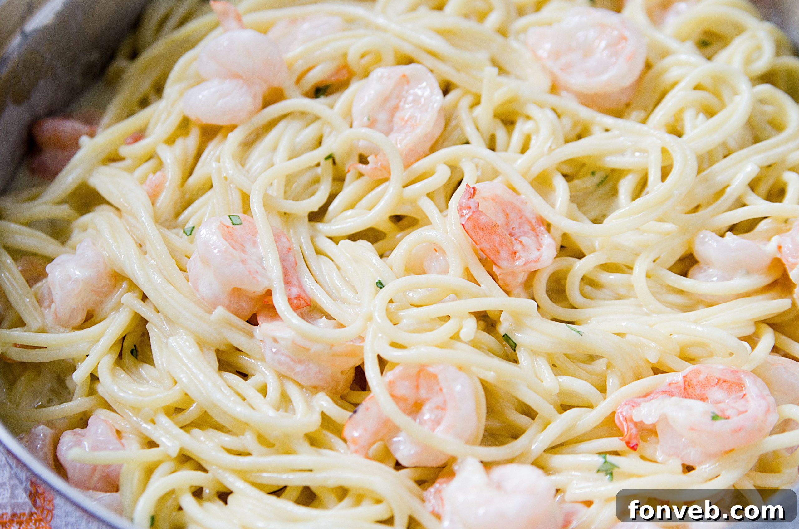 Extreme close-up of the Four Cheese Garlic Shrimp Pasta, showcasing the melty cheese and tender shrimp.
