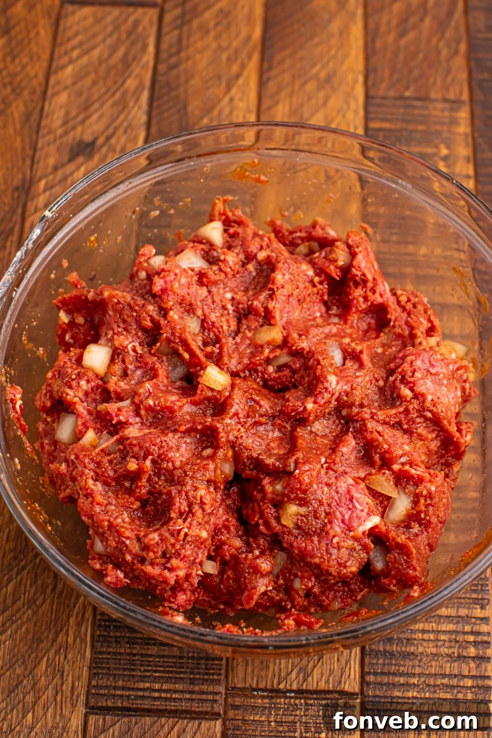 bowl of raw meat mixture for making Crockpot Homemade BBQ Meatballs