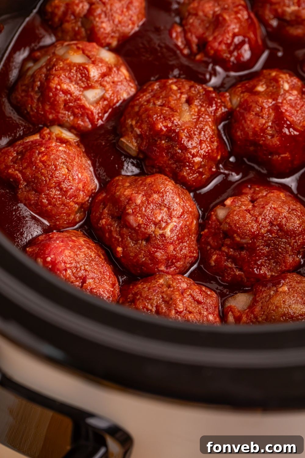 side view of Crockpot Homemade BBQ Meatballs in the CrockPot on table