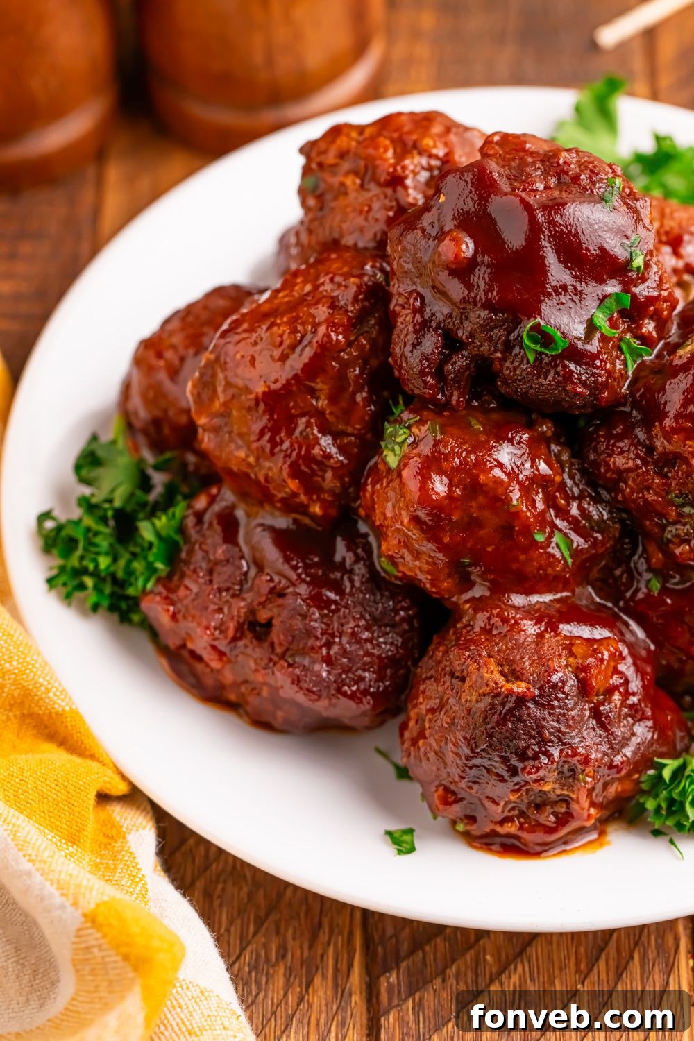 Crockpot Homemade BBQ Meatballs on a plate garnished with some parsley 
