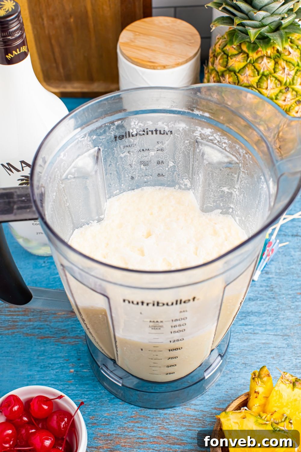 Creamy Frozen Malibu Piña Colada Delight 8 blender with Frozen Malibu Piña Colada mix in the container