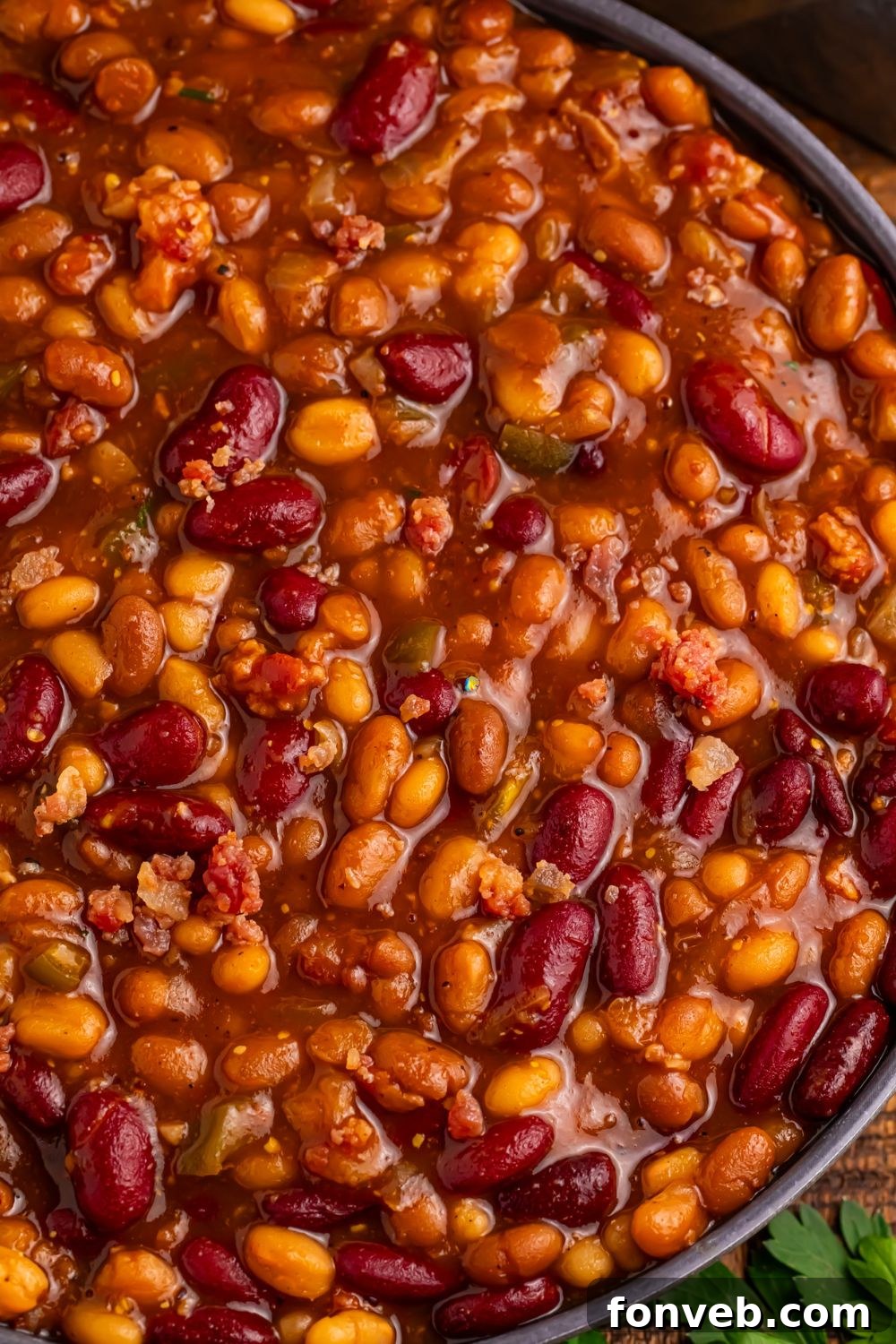 Crockpot bourbon baked beans close up in a bowl to see all the colors of beans 