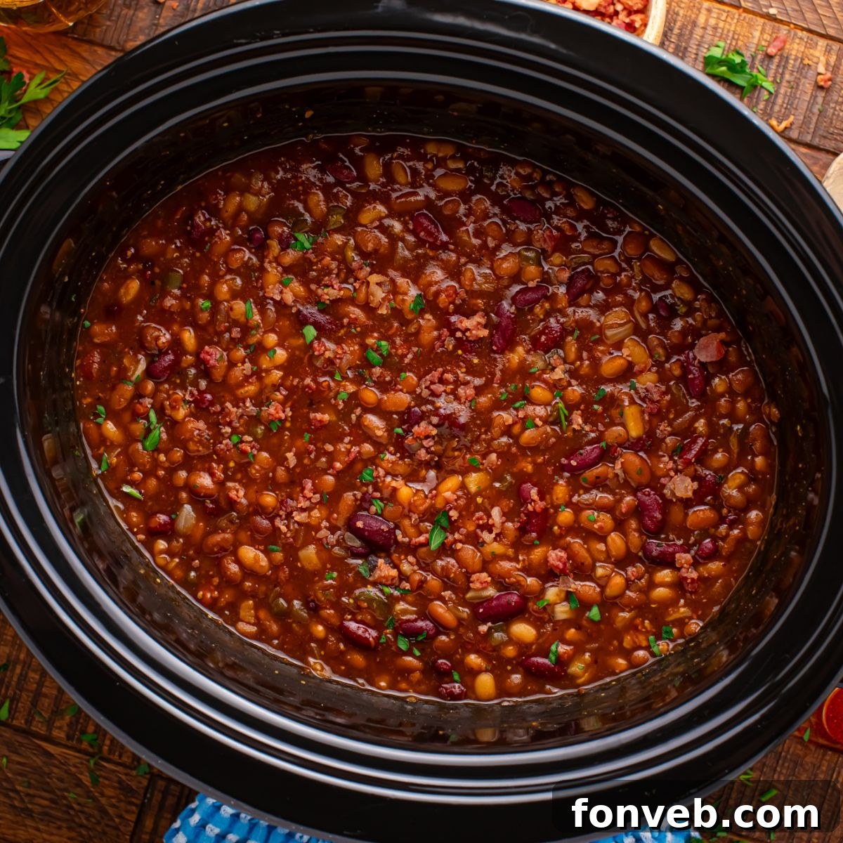 looking down to table with Crockpot Bourbon Brown Sugar Baked Beans in a Crockpot on table 