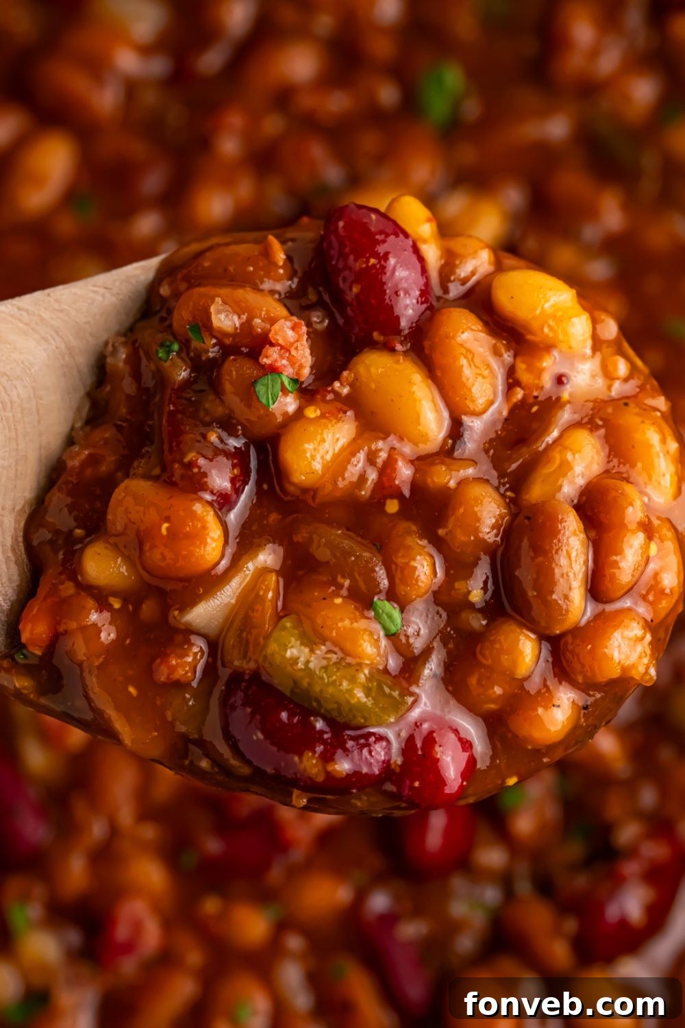 spoon with some Smoky baked beans with bourbon on them