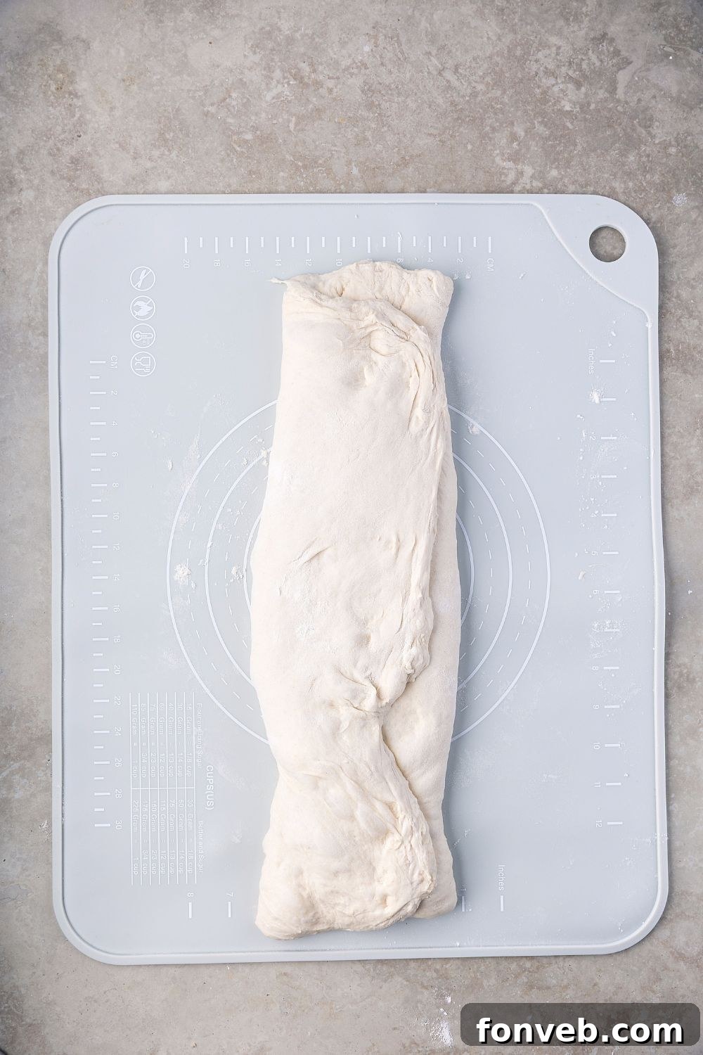 Effortless Homemade Sourdough Perfectly Crusty Always 14 Homemade Sourdough Bread dough folded up on a cutting board on table