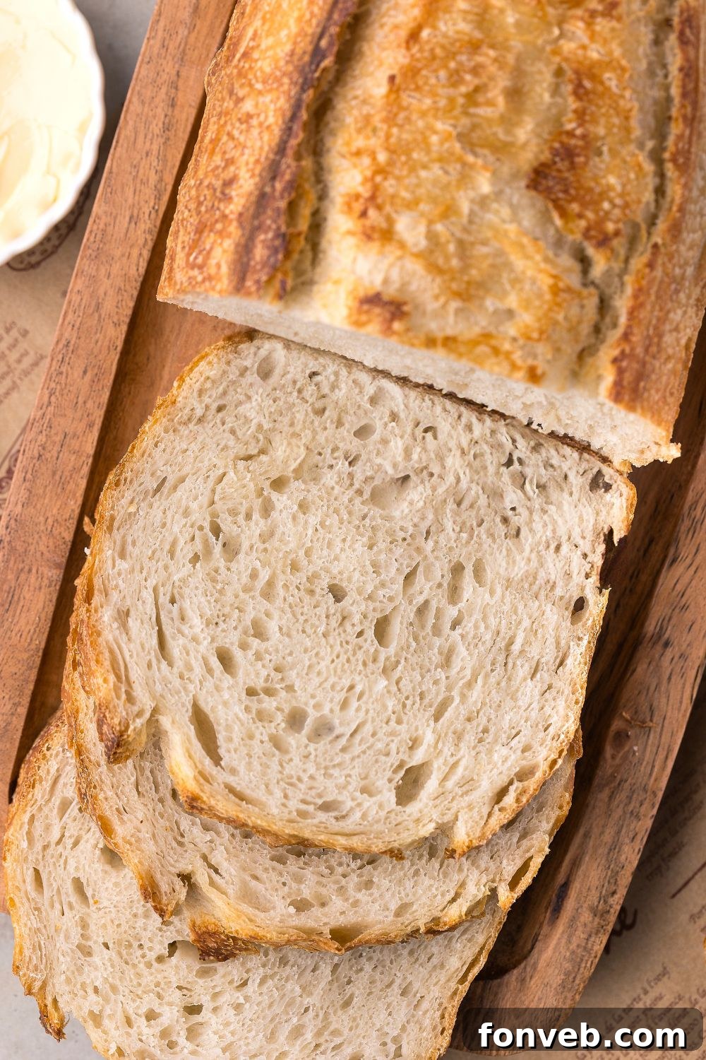 Effortless Homemade Sourdough Perfectly Crusty Always 27 Homemade Sourdough Bread on cutting board with half the loaf sliced in sandwich slices