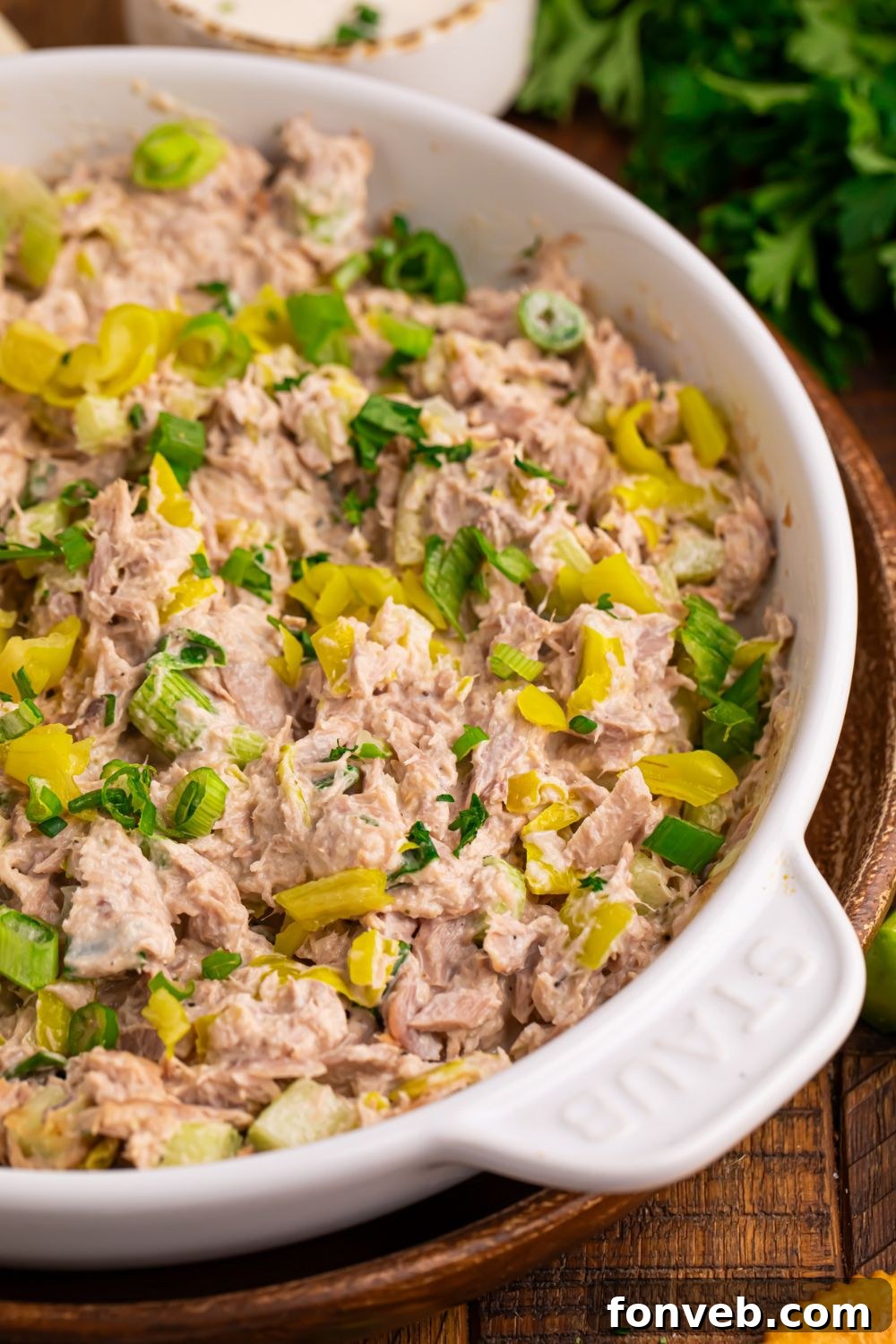 Pepperoncini Ranch Tuna Salad on table with some fresh herbs to side and salt and pepper shakers 