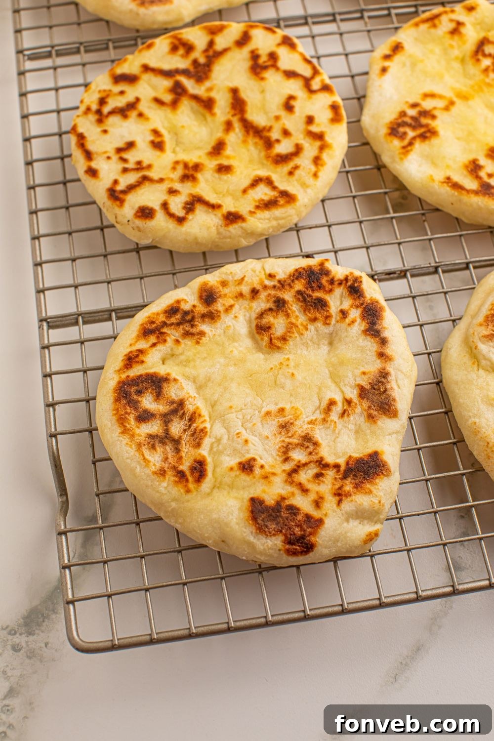 Cooked 3-Ingredient Flatbreads arranged in a single layer on a cooling rack