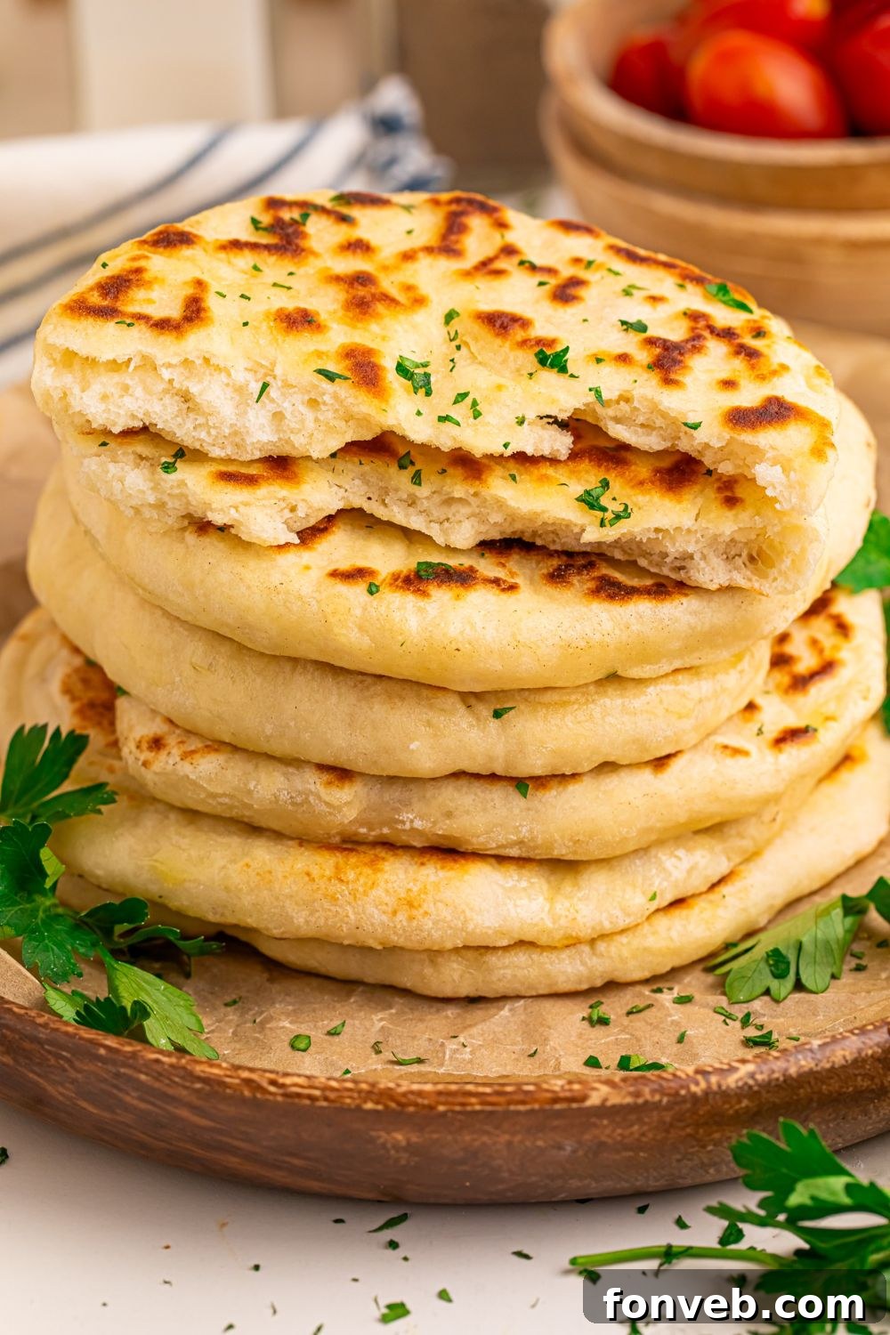 A stack of 3-Ingredient Flatbreads, with one cut in half to highlight its fluffy, airy texture