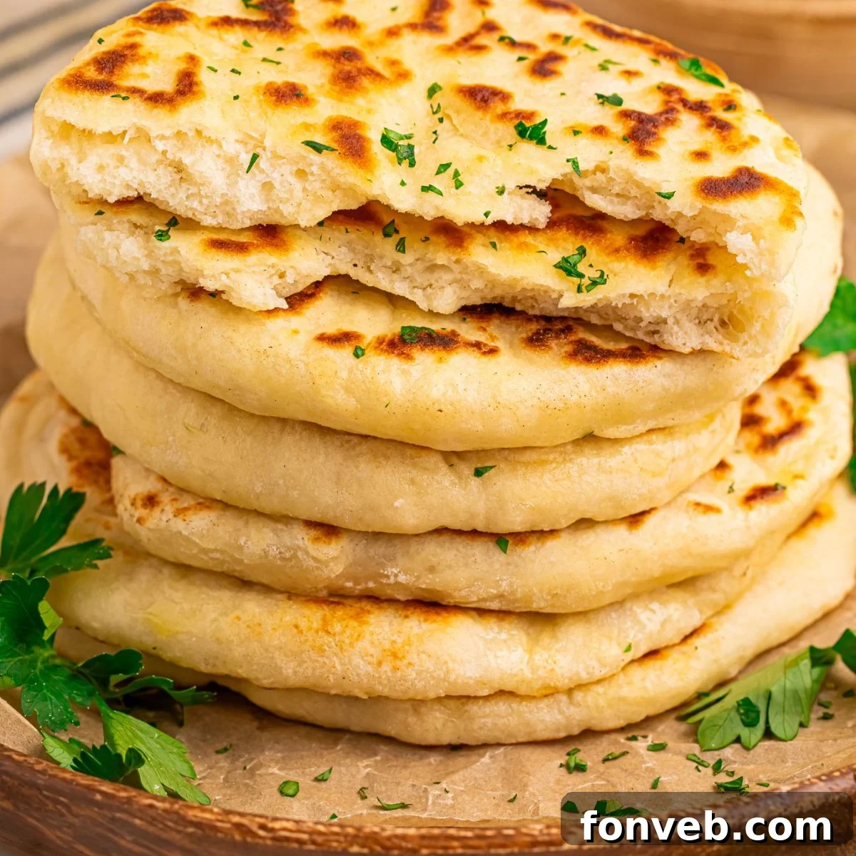 3-Ingredient Flatbreads neatly stacked on a platter, garnished with fresh parsley