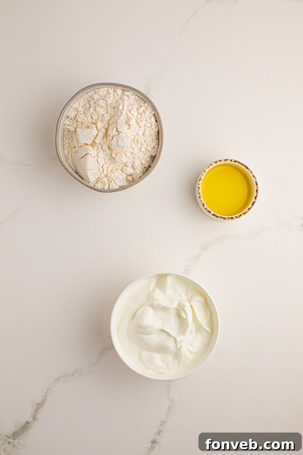 Individual bowls containing the three ingredients: Greek yogurt, self-rising flour, and olive oil