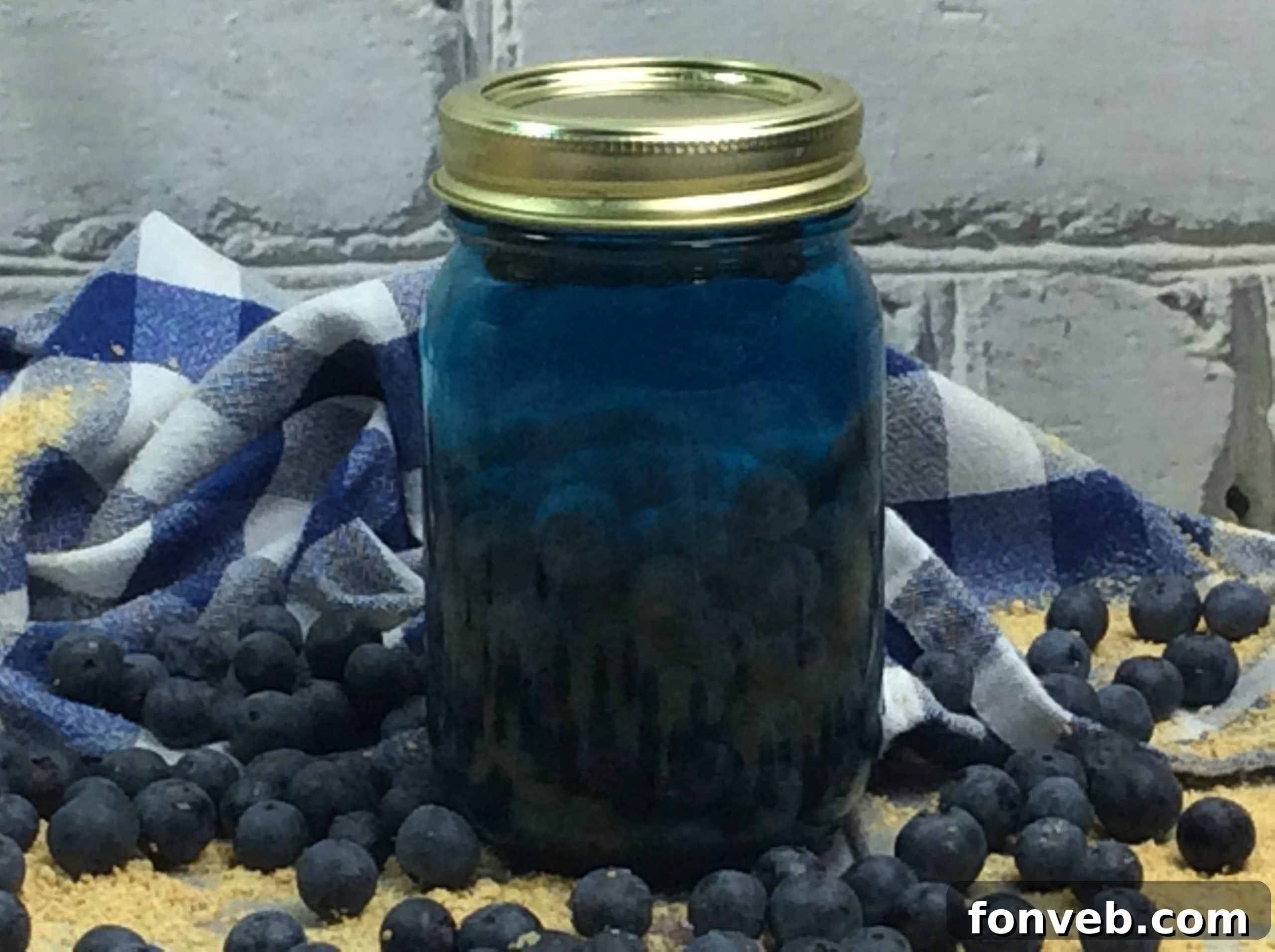 Several jars of Blueberry Cobbler Moonshine in a rustic setting