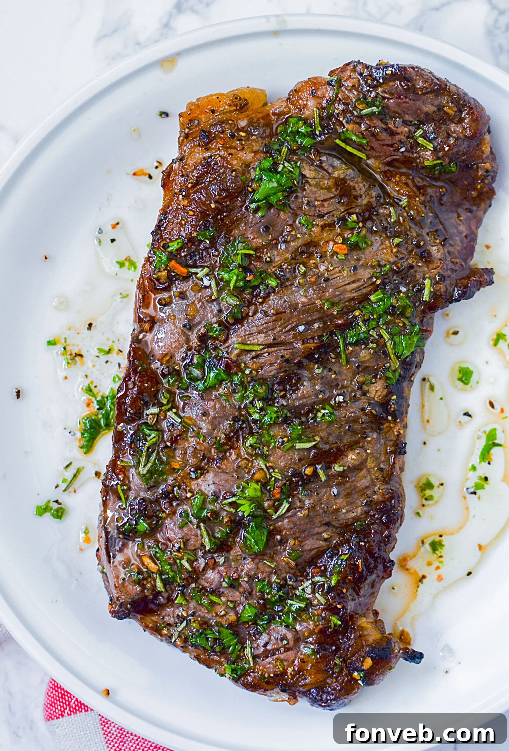 Perfectly marinated raw steak, glistening and ready for the grill, hinting at the deliciousness to come.