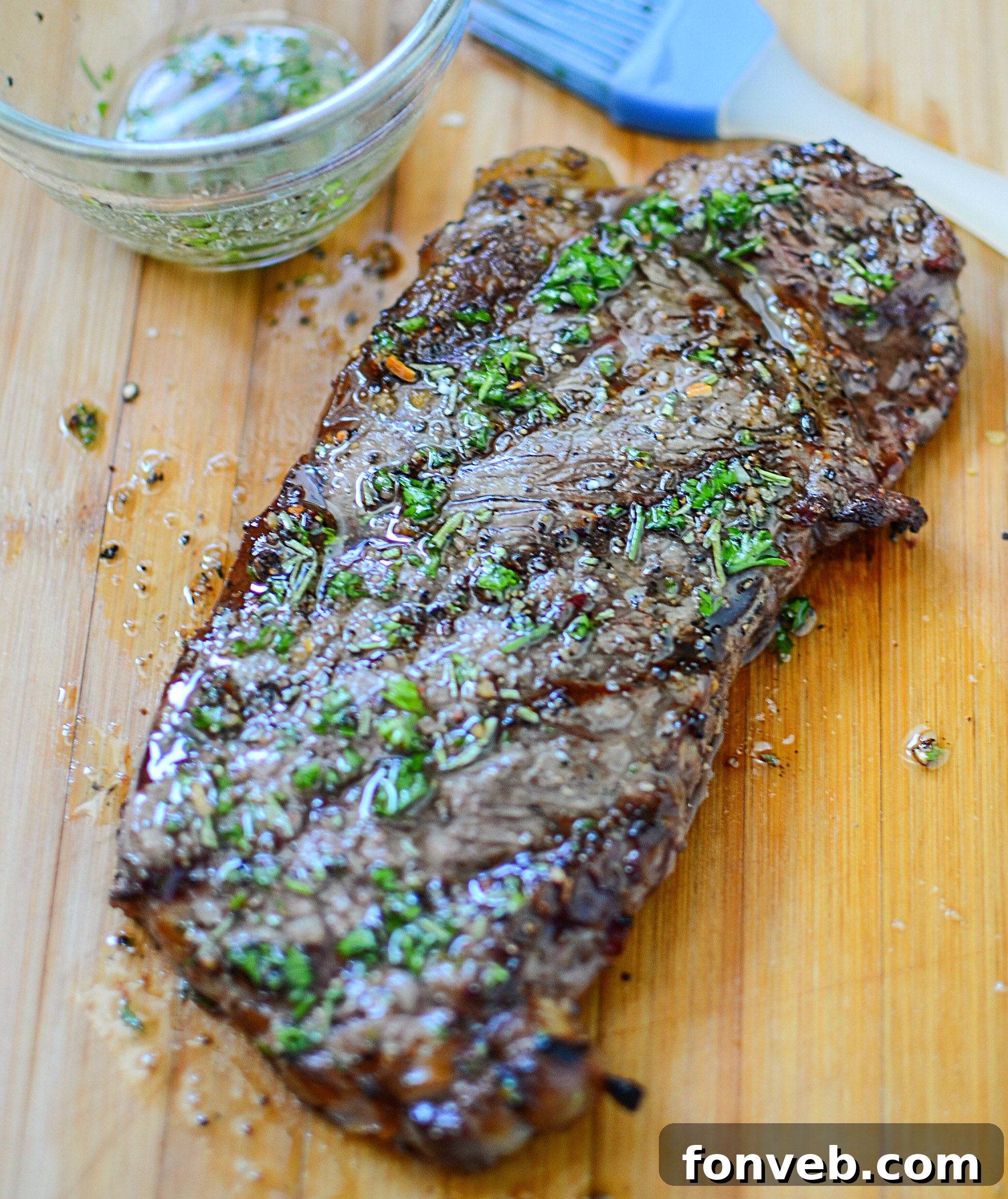 Steaks marinating in a sealed plastic bag, showing the liquid coating the meat evenly and thoroughly.