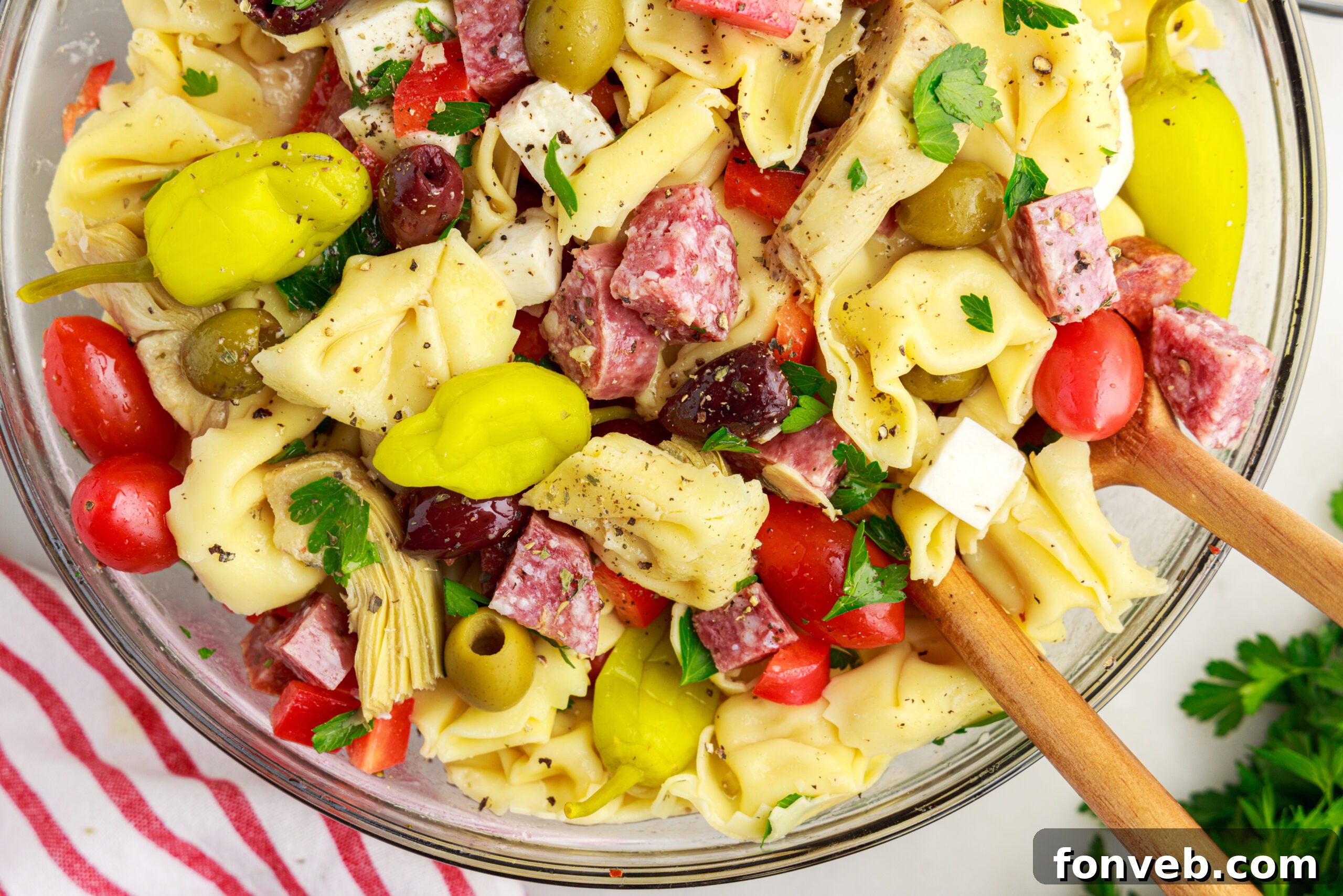 overhead shot of the Antipasto Tortellini Pasta Salad in a glass serving bowl 