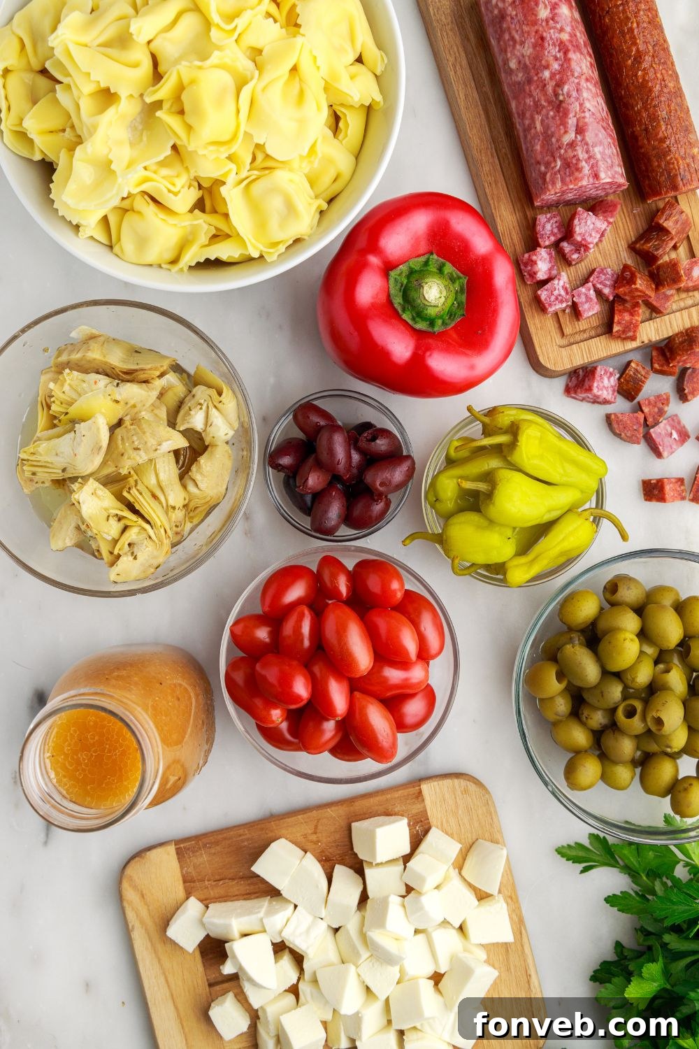 ingredients for Antipasto Tortellini Pasta Salad spread out on table 