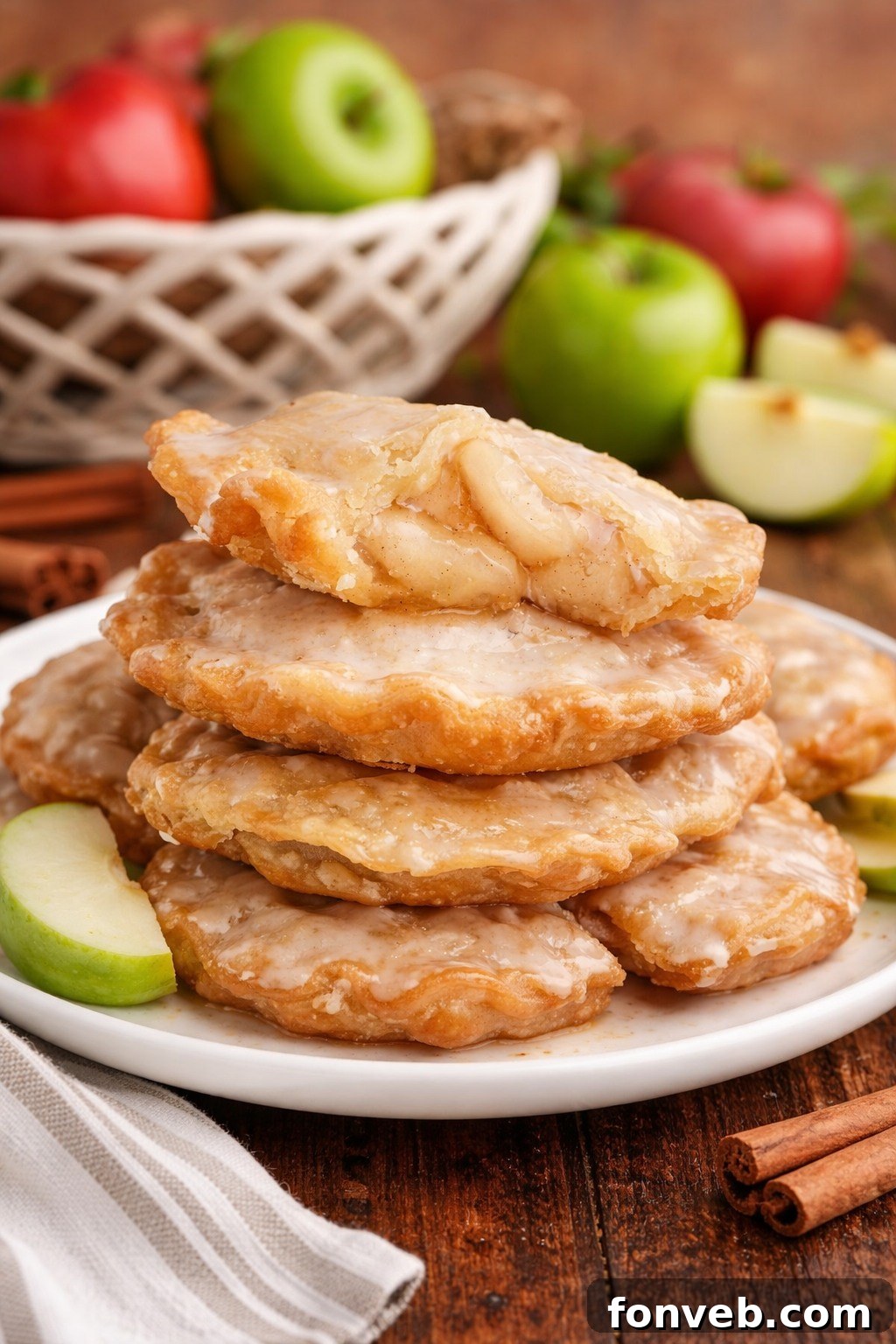 Golden Glazed Apple Hand Pies 2 Deep Fried Apple Hand Pies on a white plate stacked