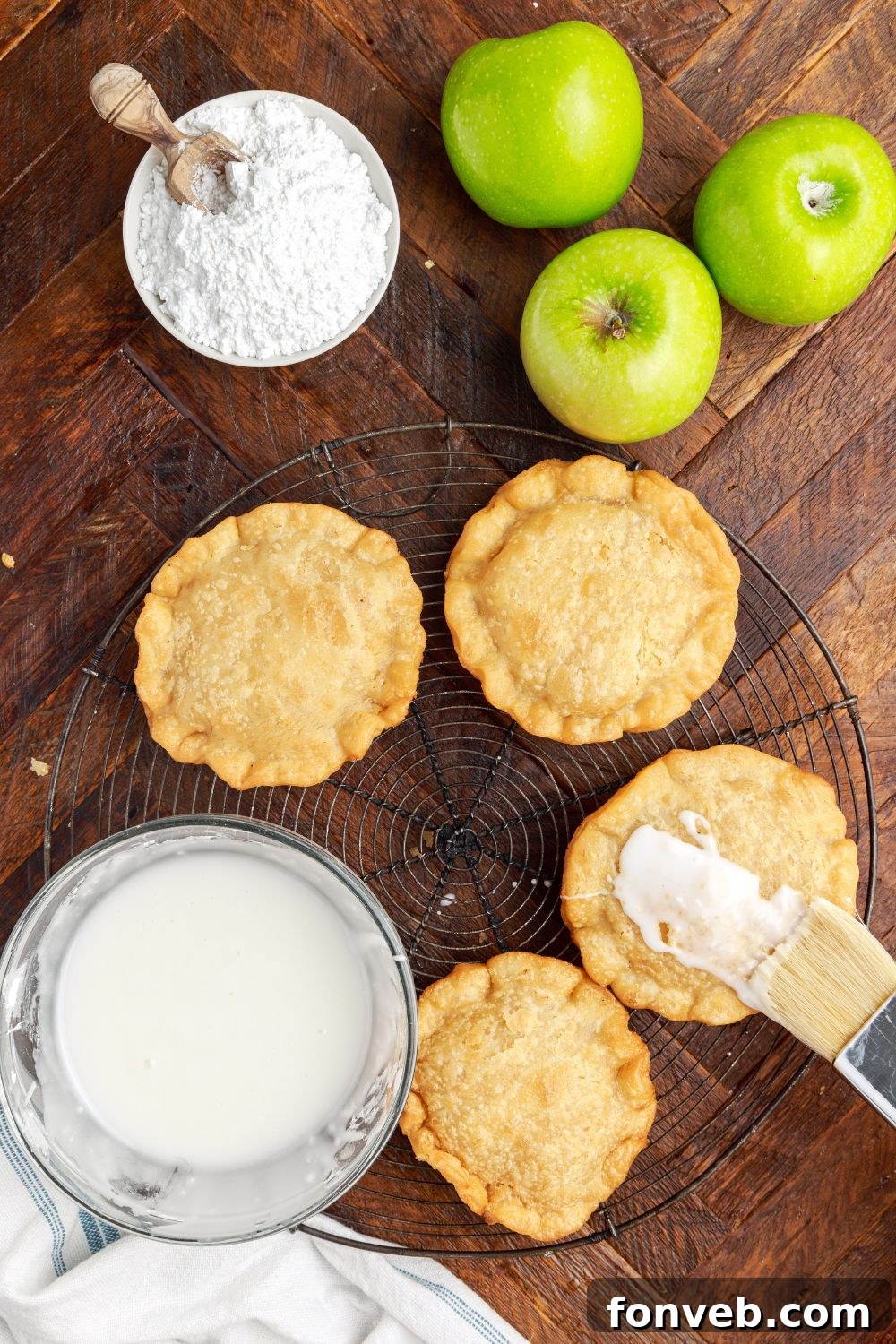 Golden Glazed Apple Hand Pies 14 glaze brushed on top of each handpie with apples