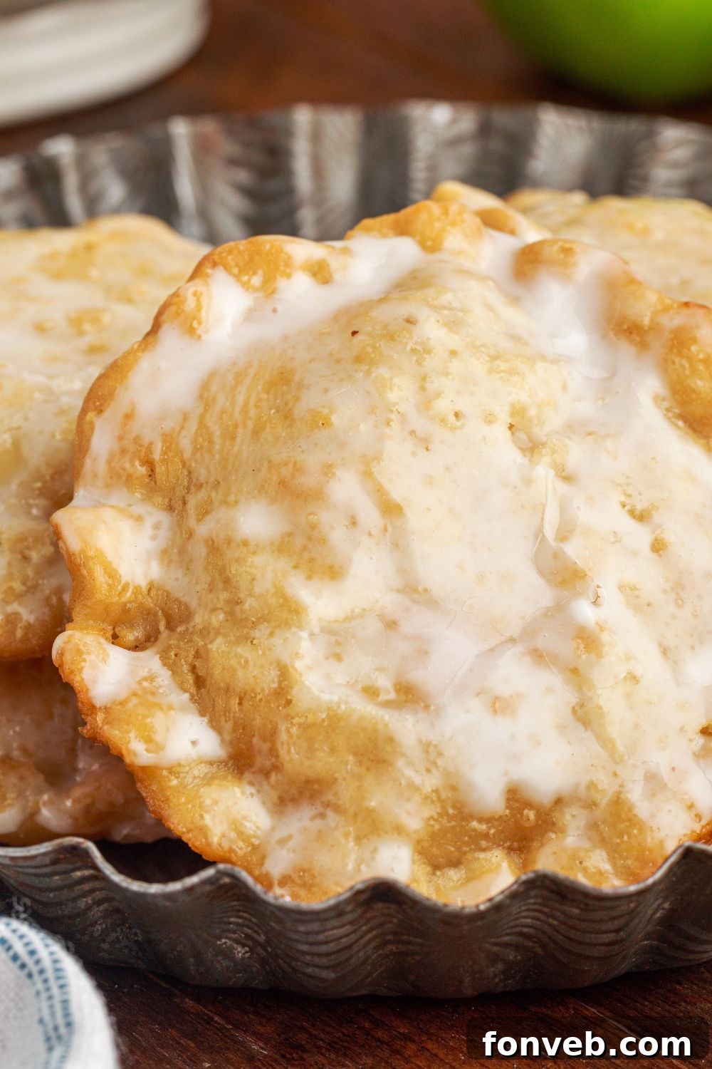 Golden Glazed Apple Hand Pies 25 Deep Fried Apple Hand Pies close up sitting on table