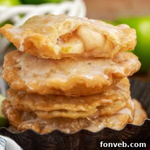 Golden Glazed Apple Hand Pies 27 stack of Deep Fried Apple Hand Pies on table