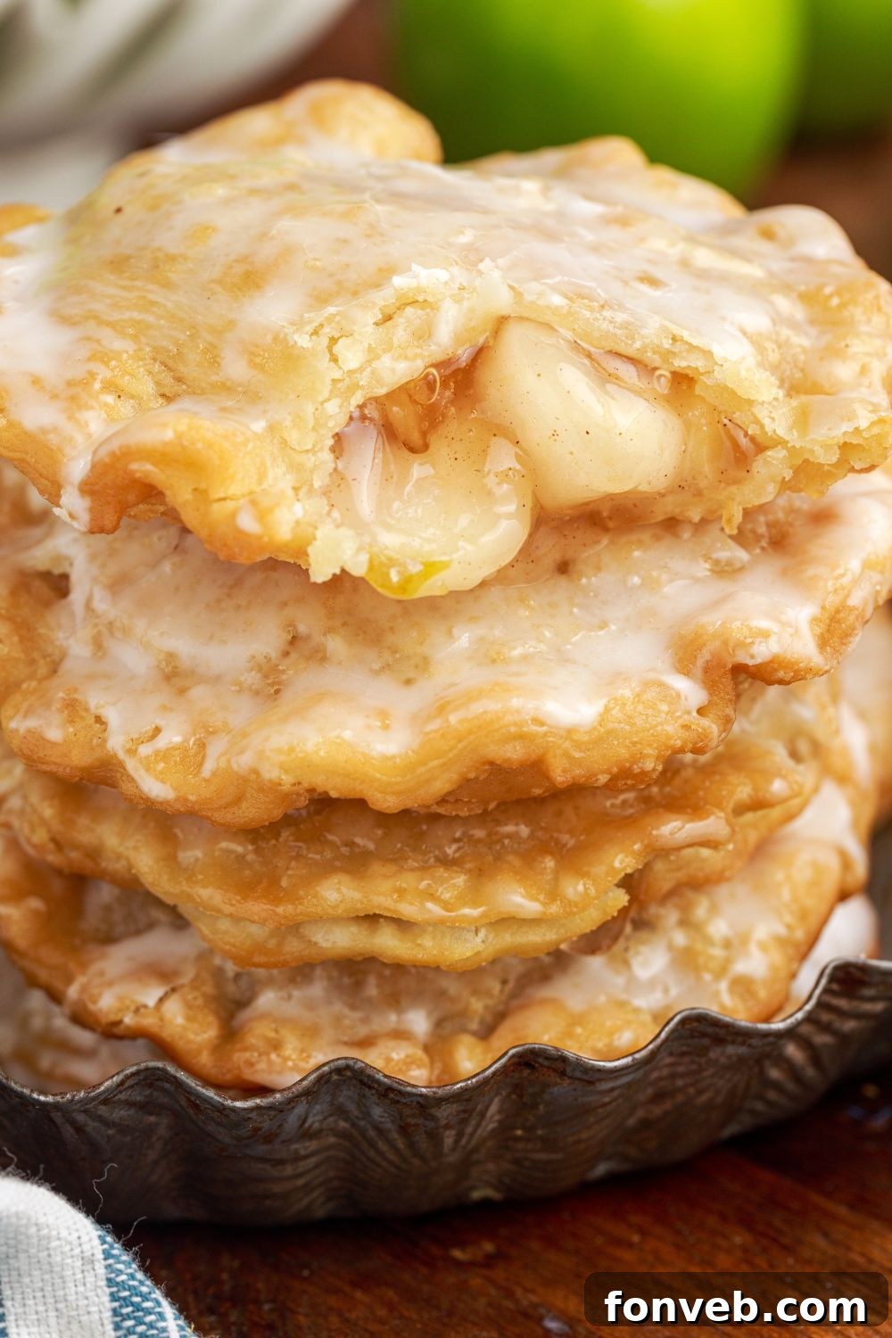 Golden Glazed Apple Hand Pies 6 stack of Deep Fried Apple Hand Pies with top one with a bite taken out of it