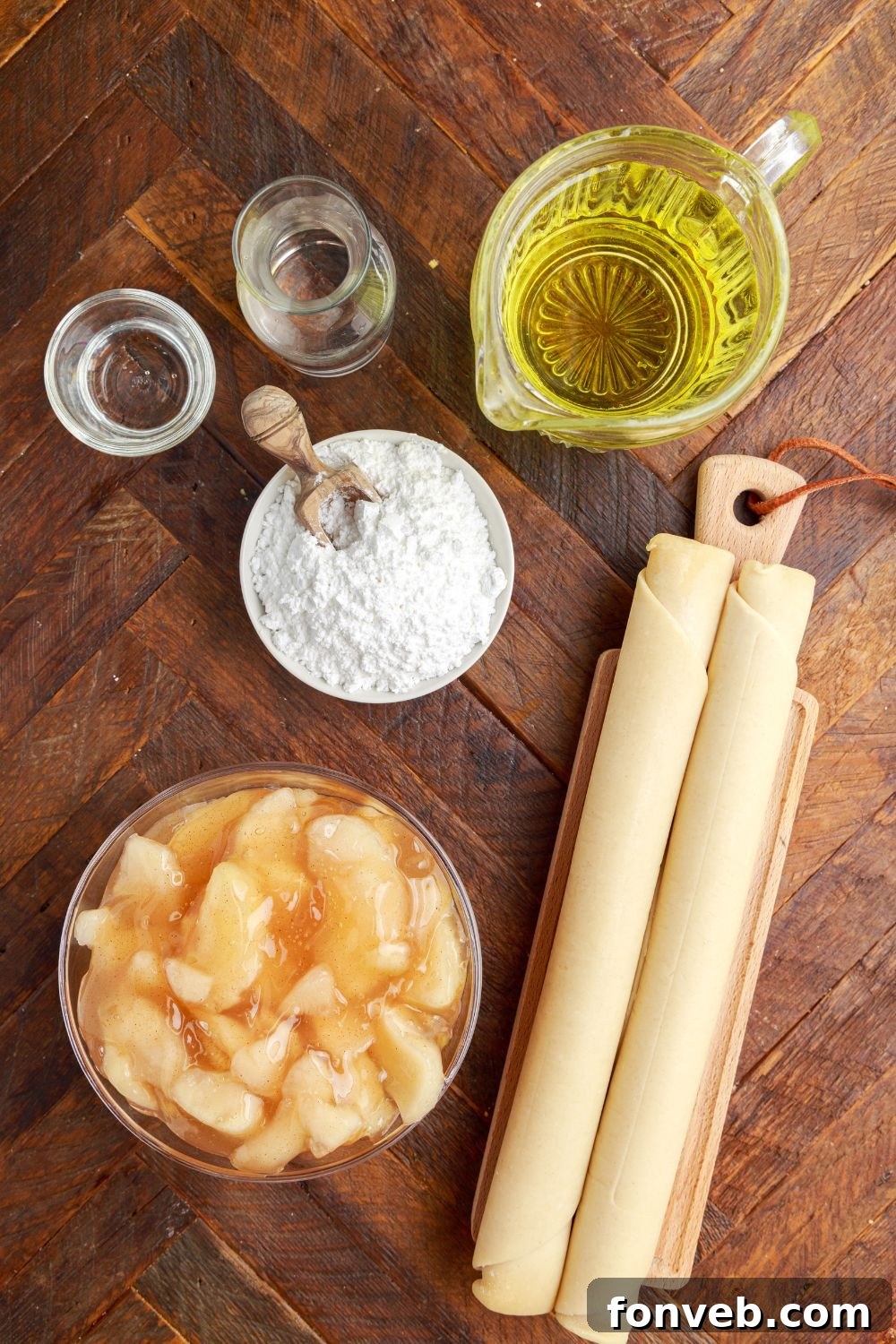 Golden Glazed Apple Hand Pies 7 ingredients for Deep Fried Apple Hand Pies in single serve containers on table