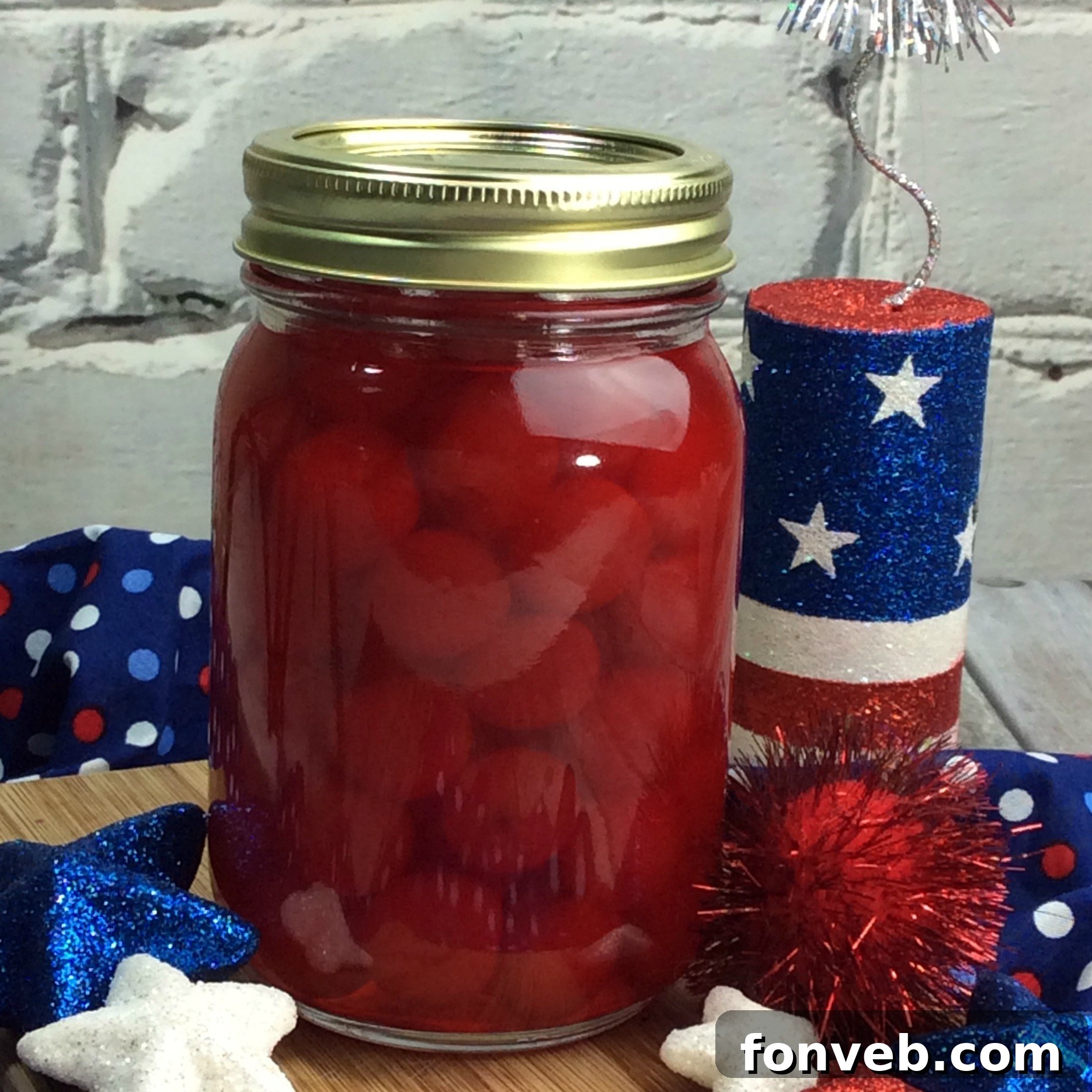 A mason jar filled with the homemade cherry moonshine, ready for serving or storage.