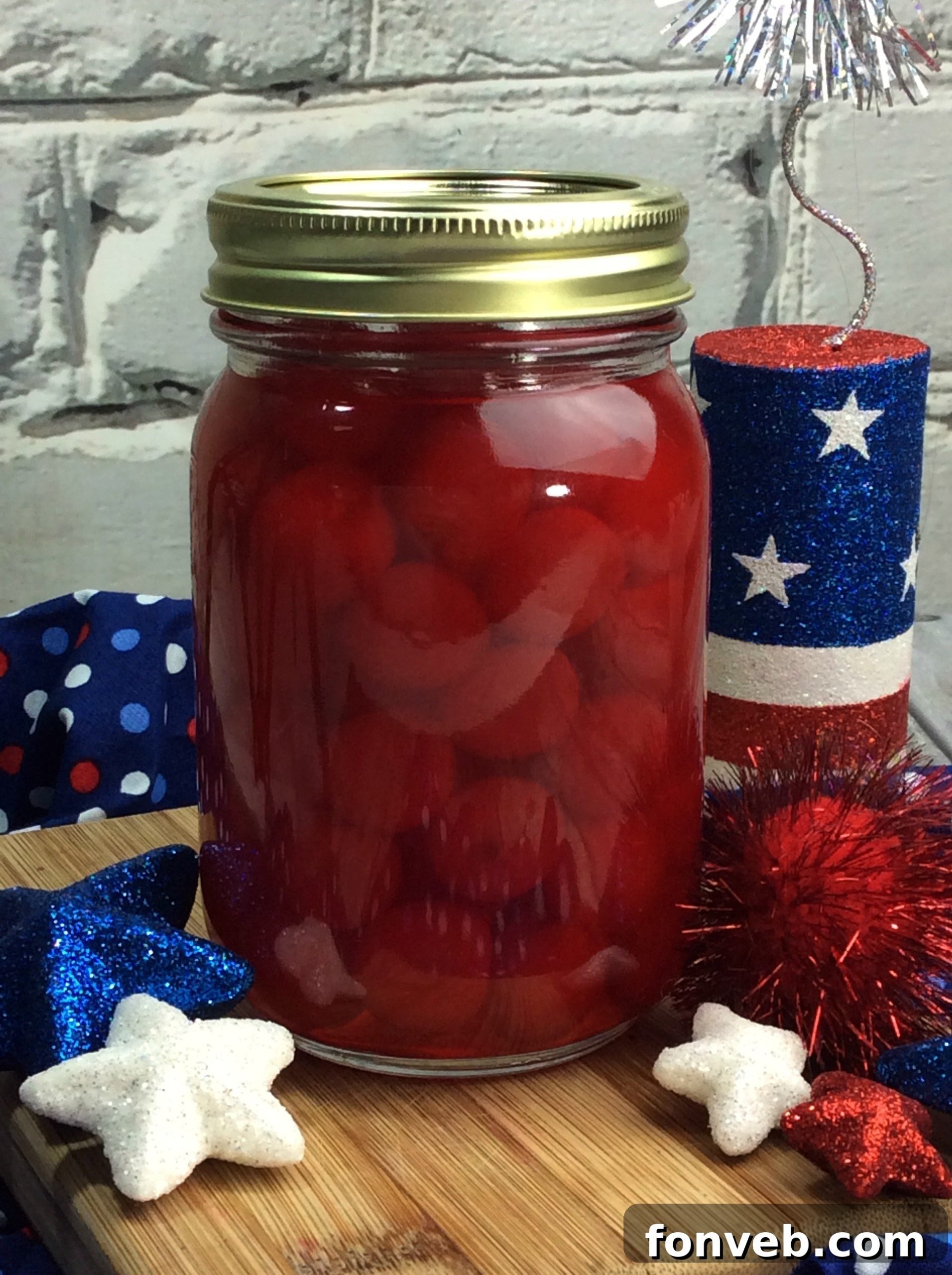 Several mason jars filled with cherry moonshine, ready for gifting or serving.